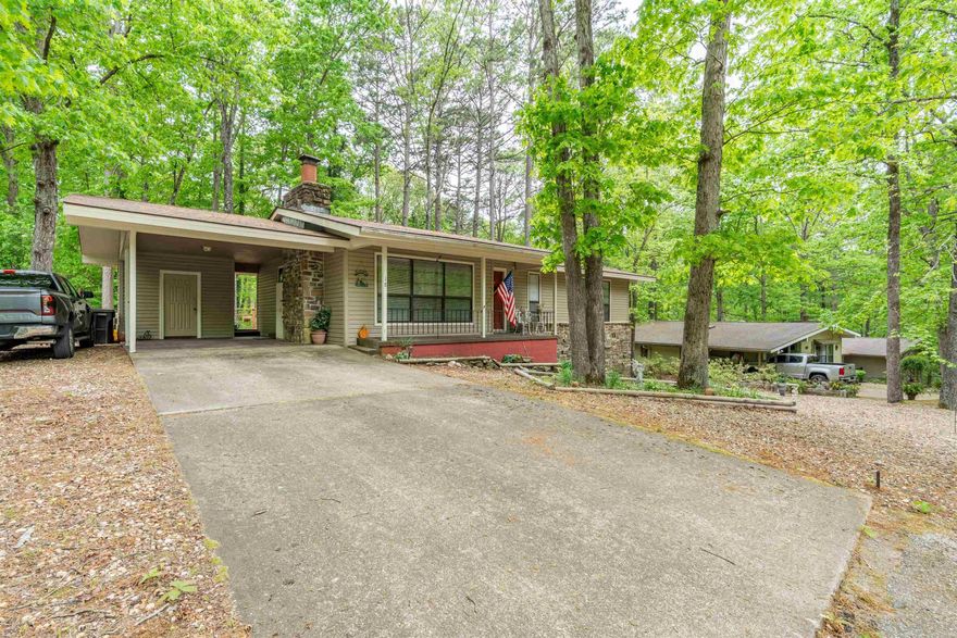 Step into this well-maintained 2-bedroom, 2 bath ranch-style home designed for comfortable, single-level living.  A welcoming living area features a wood-burning fireplace and flows easily into the dining space and kitchen.  Enjoy outdoor living on the covered back deck with additional deck space for outdoor grilling.  The home also includes a dedicated laundry room, carport and outside storage space for everyday convenience.  Updates include new heat pump in 2024, water heater in 2023 and roof replaced in 2018.  Additional storage area is located in the crawl space.  Hot Springs Village is a gated community with 11 lakes, 9 premier golf courses, 30+ miles of trails, pickleball, tennis and more!  Come see all that this home and the HSV community have to offer!  Agents, see remarks for additional details.