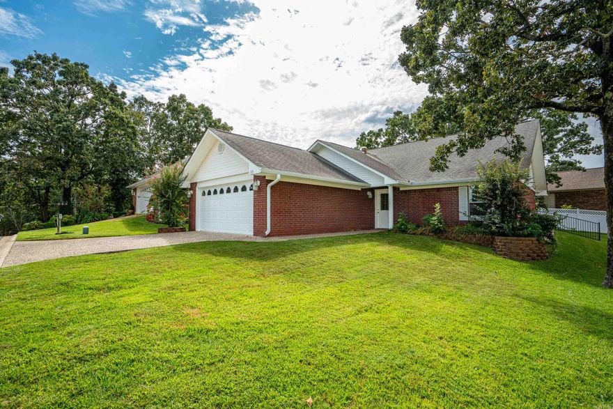 Welcome to the distinguished community of Forest View, a 55+ neighborhood where comfort and convenience meet. Perfectly positioned near the MLK Expressway, you’ll find yourself just minutes from shopping, hospitals, and the vibrant energy of Oaklawn Racing and Casino.   This thoughtfully designed home offers two bedrooms and two baths within a spacious, open floor plan of approximately 1,568 square feet. A two-car garage provides practicality, while the centerpiece fireplace promises cozy warmth on winter evenings. Step outside to discover a fenced yard—a safe haven for pets and a private retreat for its owners.  Ownership here is effortless: the Property Owners’ Association maintains the lawn and watering system, ensuring your time can be spent enjoying the tranquil beauty of your surroundings. This is more than a residence—it is an invitation to live gracefully, with ease and delight woven into each detail.