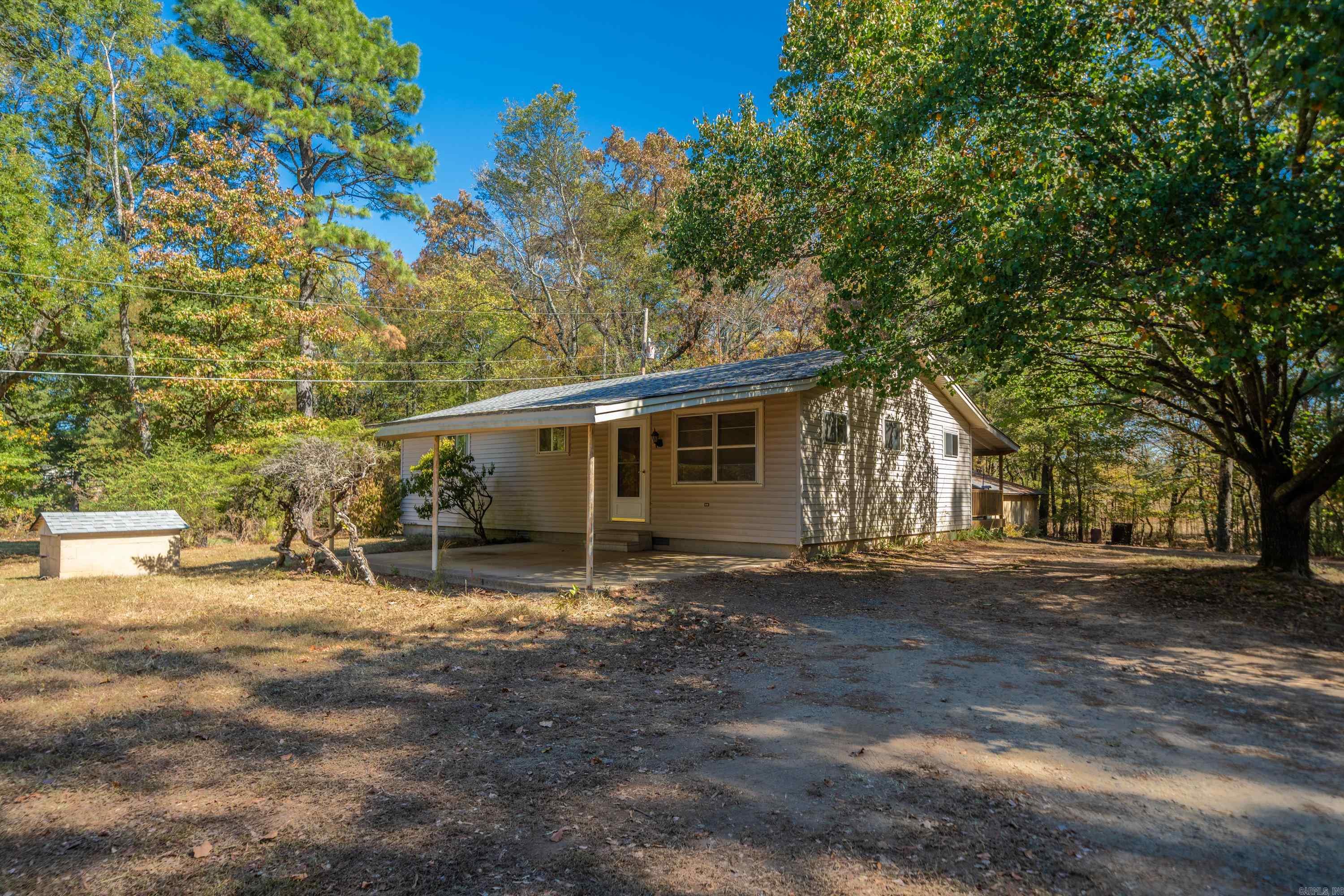 Adorable 3 bedroom home less than 1 mile to Lake Hamilton School. Home sits on 1.37 acres with a large 30x40 shop with electricity and 2 sliding drive-in doors. Shop also has I-Beam mono rail for pulling engines and pulling eyes in the concrete for bending car frames, perfect for the car mechanic or just someone who likes to tinker. Large covered porch across back of house to watch the wild life and a one car carport. Central heat and air, hardwood floors and one car carport. Home has had one owner for over 40 years! This would make a great investment property or first time homeowner and would qualify for Rural Development loan with zero down! New roof on house and shop and city water is at street but seller never hooked up. All offers subject to probate court approval.