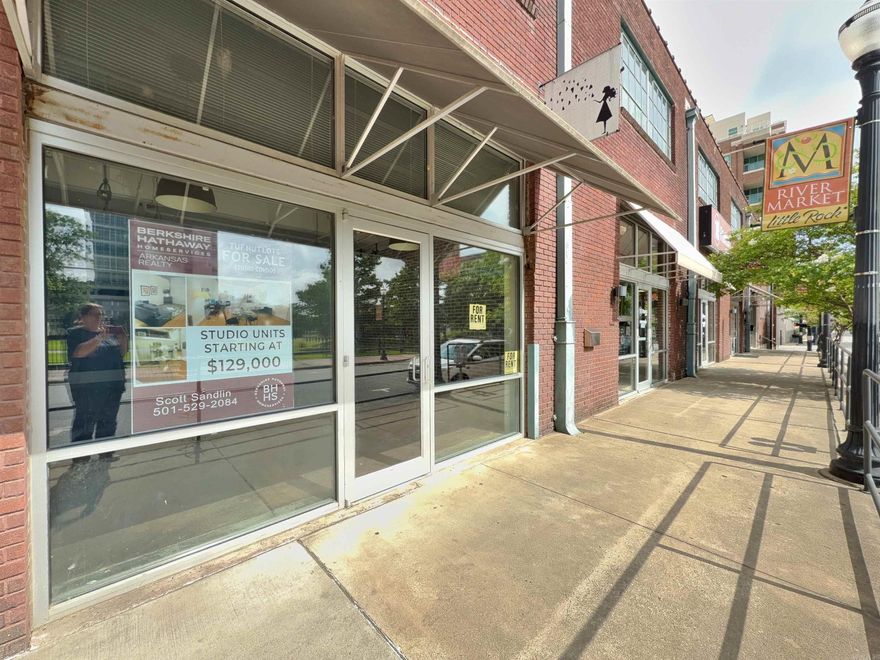 PRIME DOWNTOWN LOCATION Step into the vibrant energy of downtown with this rare opportunity. Located in the iconic Tuf Nut Lofts—formerly home to the legendary blue jean factory. Now officially listed on the National Historic Register, the building showcases post and beam construction, soaring 15-foot ceilings, and exposed brick walls that echo its storied past.  Located within unbeatable walking distance to the River Market, River Trail, local gyms, parks, restaurants, and more, this space delivers on location, lifestyle, and legacy.