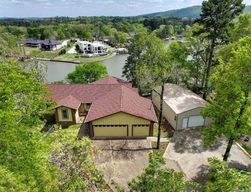 Welcome to 120 Silverwood Terrace! Nestled at the end of the street, this home offers privacy on almost 1 acre of land on the beautiful shores of Lake Hamilton. The home boasts lake and mountain views. Relax on the newly installed aluminum deck or take a ride down the cart path to hangout on your very own dock with swim platform that has new wood and has been Permasealed. This property includes a 24X40 shop and a 12X16 storage shed for all your extra toys. The floor plan of the home is very functional and has a beautiful sunroom to sip your favorite beverage from and marvel over the fantastic view. List of improvements made in the last year in associated docs. So much work has been done you won't need to do a thing but move in and start enjoying lake life on Lake Hamilton.