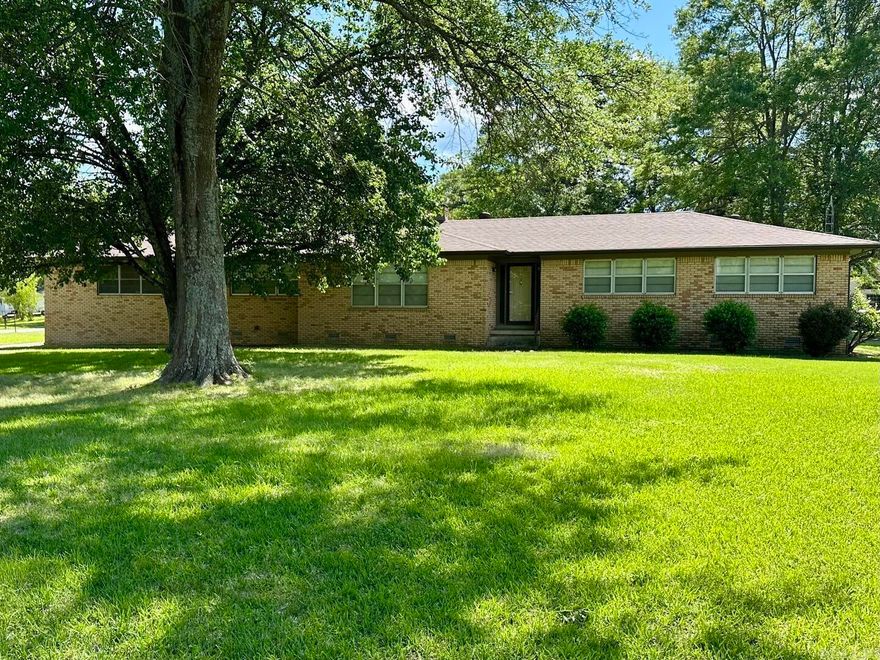 Discover the charm of this classic one-story brick home, meticulously maintained for today's lifestyle. Nestled on a sprawling 1.5 acres, with a convenient circle driveway, this property offers a wonderful blend of vintage character and modern updates. Inside, you'll find a spacious 2,066 square feet of living space providing, 3 bedrooms and 2 beautifully remodeled bathrooms. The updated flooring flows seamlessly throughout the home, creating a fresh and inviting atmosphere. The expansive living room, features a cozy gas log fireplace. For more formal occasions, a dedicated dining room awaits. The kitchen and den combine in a desirable open floor plan, making everyday living a breeze. A second gas log fireplace in the den adds warmth to this casual living space. Car enthusiasts or those needing extra space will appreciate the oversized two-car attached garage, complete with a huge storage room. But that's not all! This property also boasts a new shop offering 1,320 square feet of space, overhead door and side entry. Additional storage shed for extra equipment. Enjoy vintage character with the peace and privacy, while still being in a great location! **See Agent Remarks