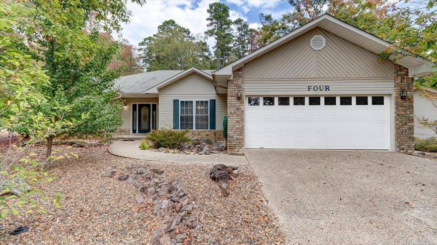 Welcome home to this beautiful one level gem in the Hot Springs Village community.  This 3 bedroom, 2.5 bath corner lot home is move in ready with spacious open floor plan and living area with a cozy fireplace. With fresh paint throughout and professionally cleaned carpets, this home is move-in ready.  The kitchen has ample cupboard space, including a large pantry.  The large deck overlooks a serene wooded lot surrounded by the beauty of nature. The low-maintenance yard ensures you'll have more time to relax and enjoy life's pleasures.  Hot Springs Village offers you access to an array of community amenities, including golf courses, pickle ball courts, walking trails, community center, restaurants and stunning lakes. 1st time owners have onetime $1500 buy in fee paid to POA