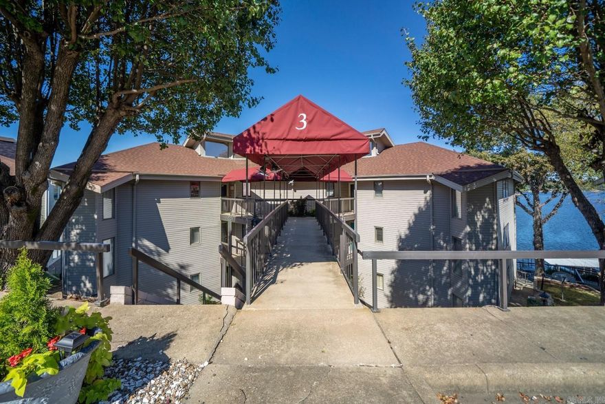 Offering commanding views of Lake Hamilton, this waterfront condo is situated in a prime 7South gated community. A successful short-term rental, this luxurious three-bedroom, two-bathroom condo underwent a complete remodel in 2020. Turn-key furnished - don’t miss this fantastic opportunity. High-end finishes adorn this condo, including LED fireplaces with Roman clay plaster, granite kit countertops, quartz vanities, and two balconies. Updates include HVAC system, appliances, Shaw LVP flooring, three sliding patio doors, water heater, Carrara marble kitchen backsplash with granite chiseled edge countertops, a custom wooden vent hood, quartz bath counter, new tile in the dining room, custom brick accents, LED fireplace with Roman clay plaster finish, cordless pleated window shades, LED can lights, built-in bunk beds. Outside, enjoy a covered boat slip, reserved parking spot, pool, tennis court, and boat trailer storage.
