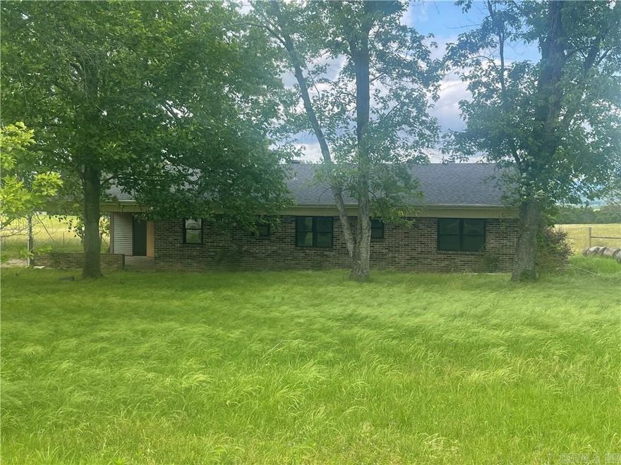 SWEET COUNTRY LIVING with A SURREAL VIEW & QUIET SETTING. This brick beauty and its detached shop/garage offer a rural, peaceful haven. The mountain view is unbelievable. Home boasts a NEW ROOF, additional sunroom. Roomy floor plan consists of: a kitchen, formal dining room, large family room with fireplace/insert, 3 bedrooms, and a sunroom/game room/4th bedroom. Closets everywhere. All electric dwelling is definitely spacious and priced realistically. The detached garage has rooms modified for possible offices, and there are stables attached to the exterior. Potential to be a small hobby farmette or just a blissful country oasis.