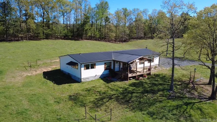 Turnkey 46.15-acre farm with beautiful land, abundant water, and room to live the country lifestyle you’ve been dreaming of.  Established pastures, cross-fencing, and open ground ideal for livestock, horses, or simply enjoying wide open space. A spring-fed, year-round creek and multiple ponds provide a stunning natural setting along with reliable water sources.  The 50x40 insulated barn offers concrete floors, electricity, and attached sheds—perfect for equipment, hobbies, animals, or storage. Custom 3-br, 2-ba mobile home offers approximately 2,280 sq ft with a spacious living room and fireplace, dedicated office, and a thoughtfully designed layout. Beautiful kitchen features abundant storage, generous countertop space, a large island, and plenty of windows that fill the home with natural light. Primary suite includes a soaking tub, tile shower, and walk-in closet. Covered front and back porches overlook rolling pastureland—ideal for relaxing and taking in peaceful country views. Additional improvements include a 20x30 cabin.1500-gallon septic system in place. Located near Shady Lake, the Cossatot River, Caddo River, and Lake Greeson.