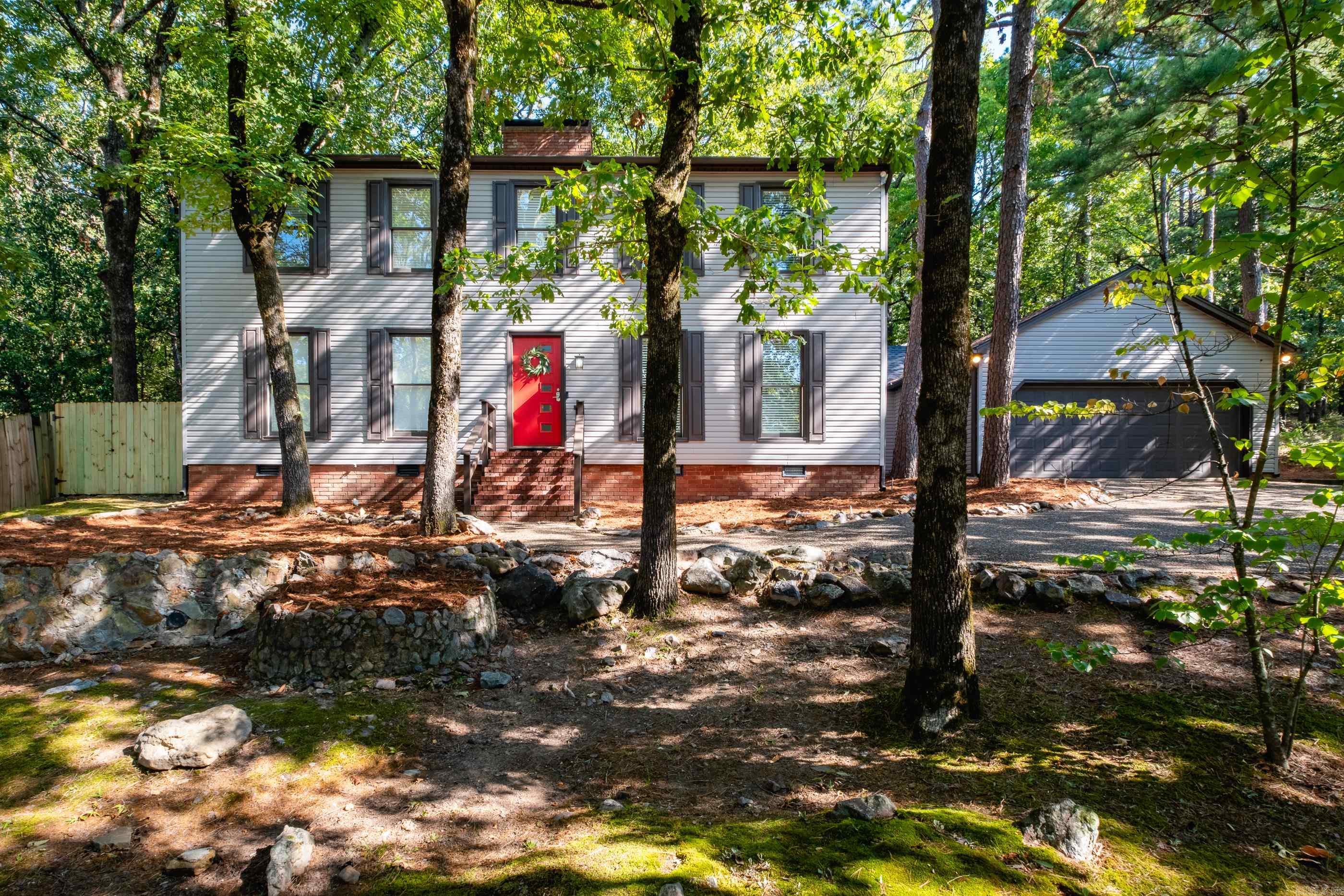 Conveniently located near schools, shopping, restaurants, this 0.42 acre wooded oasis is one to see! Downstairs offers the primary suite, large dining room, spacious eat in kitchen, living room with a fireplace, and primary suite. The upstairs includes 2 large guest rooms, vaulted ceiling study with built-in desks and bookshelves, large walk-in closets, walk-in attic and a full bathroom with a double vanity. The carpet in the upstairs is new. The storage within this house is extensive. Outside you'll find a screened in porch and a deck for entertaining or relaxing while watching and listening to the many birds. The neighborhood includes a wonderful pool, playground, tennis courts and pond. Roof is 1 year old and HVAC is approx 5 yrs. 12 new windows are on order. Agents see remarks.