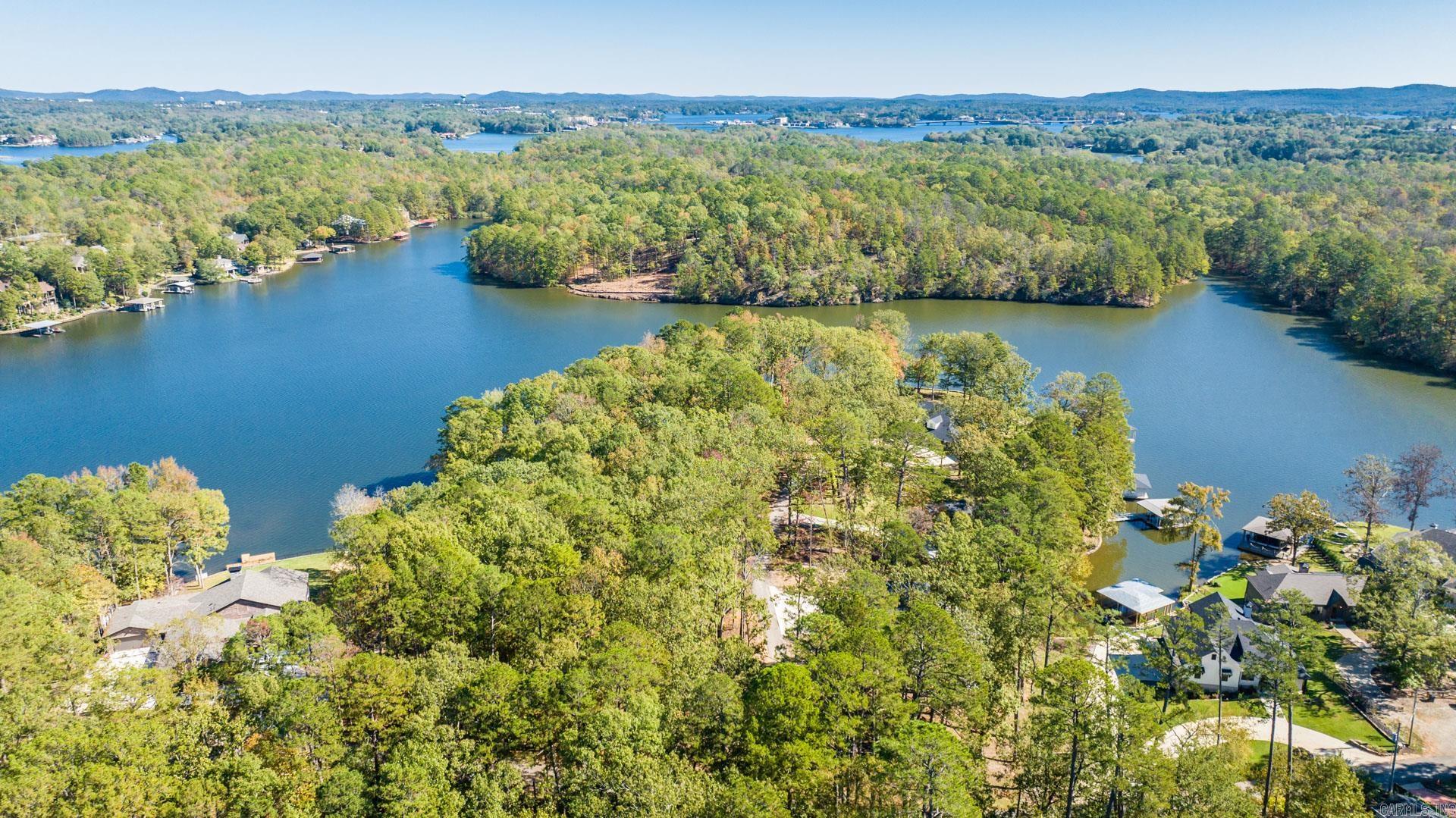 Experience unparalleled serenity and breathtaking beauty on this 2.57-acre lot located on the coveted shores of Lake Hamilton in Hot Springs, Arkansas. With over 600 feet of pristine lake frontage, this property presents a rare opportunity to build your dream waterfront estate. Embrace the tranquility of lakeside living while enjoying the convenience of being just minutes away from local amenities. The property boasts mature trees, providing both privacy and a lush natural environment. The gentle slope to the water ensures easy access to the lake, making it perfect for boating, fishing, or simply enjoying the stunning sunsets over the water. This exceptional lot could provide enough room for two luxurious homes within a peaceful atmosphere. The expansive shoreline offers numerous possibilities for a private dock, boating facilities, or a waterside gazebo. Whether you are looking to build a year-round residence or a vacation getaway, this property provides the perfect. Your dream of lakefront living awaits!