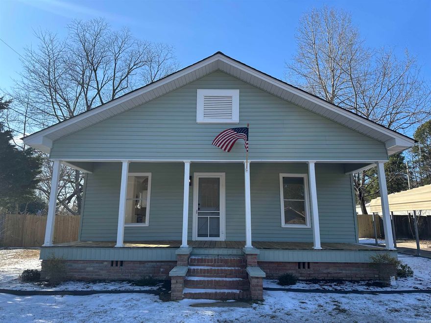 Relax and take in the fresh country air on the large front porch of this super cute, country charmer!  New paint, new roof, new HVAC, new hot water heater, updated electrical and plumbing and more.  Fully updated and renovated throughout with all the modern amenities you could ever want.  Country living, minute from town.   The large kitchen offers a copper farm sink that is paired with beautiful butcher block counters and all new white cabinets. Plus you will enjoy a gas range that any chef can appreciate, complete with a full stainless steel appliance package including dishwasher, refrigerator, microwave and a separate laundry room equipped with washer and dryer. You will have plenty of room to bring friends and family together in the large living room and dining area for some great memories around the fireplace.  The front two bedrooms have ample closet space and share a large Jack and Jill  bathroom with tub and shower combo.  The back bedroom has vaulted ceilings and a private screened in porch. The back  door leads to a fenced in back yard with two large storage/shop buildings.   There is a covered 2 car carport with plenty of extra parking and the fully paved driveway.