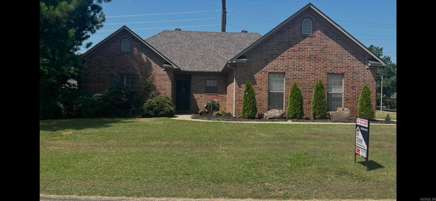 Sitting on a generous .70 acre corner lot, this home features a good-sized living room, split bedrooms, three bedrooms and two baths.  The kitchen has painted cabinets, ceramic tile floors and a breakfast bar. The Spacious primary suite has a walk-in closet.  The hall bath has double vanities.  The home has a laundry room with storage.  It has a side entrance garage  and nicely landscaped.  The property does not have a fenced yard, but there are no restrictions against having a fenced backyard.