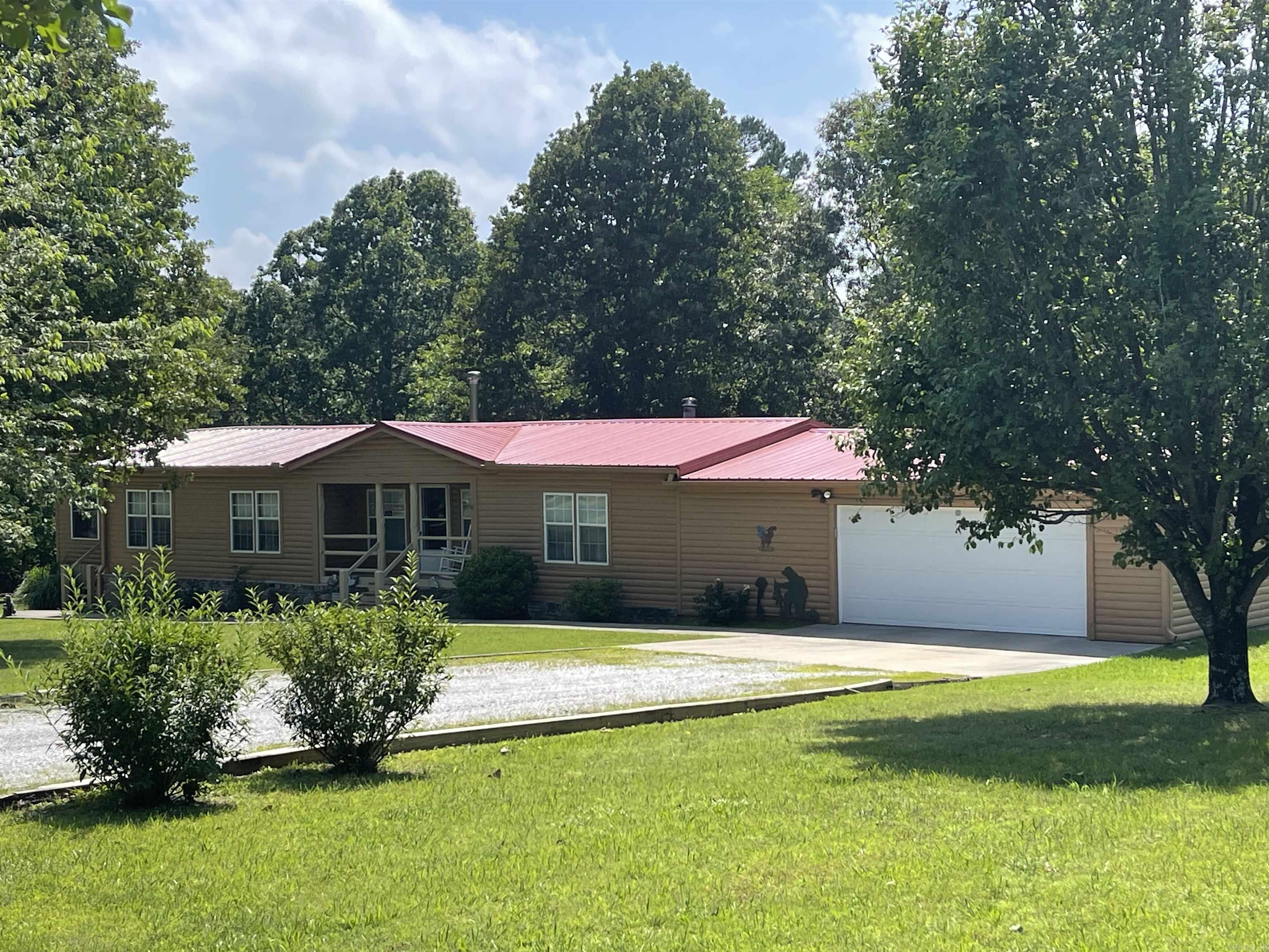 Well-manicured and stunning 2220 sq ft, 3 bedrooms, 2 bath home on 1.55 acres of beautifully landscaped property, just minutes from downtown Mountain View, Arkansas. This charming residence features a cozy woodstove, a 2-car garage, and ample space to make it your own. The property also includes a bonus detached hobby building with climate control, perfect for a home office, workshop, or art studio plus a large storm shelter. Additional features include a Generac generator, ensuring you're always prepared. Don't miss out on this incredible opportunity to own a piece of paradise in the heart of the Ozarks!