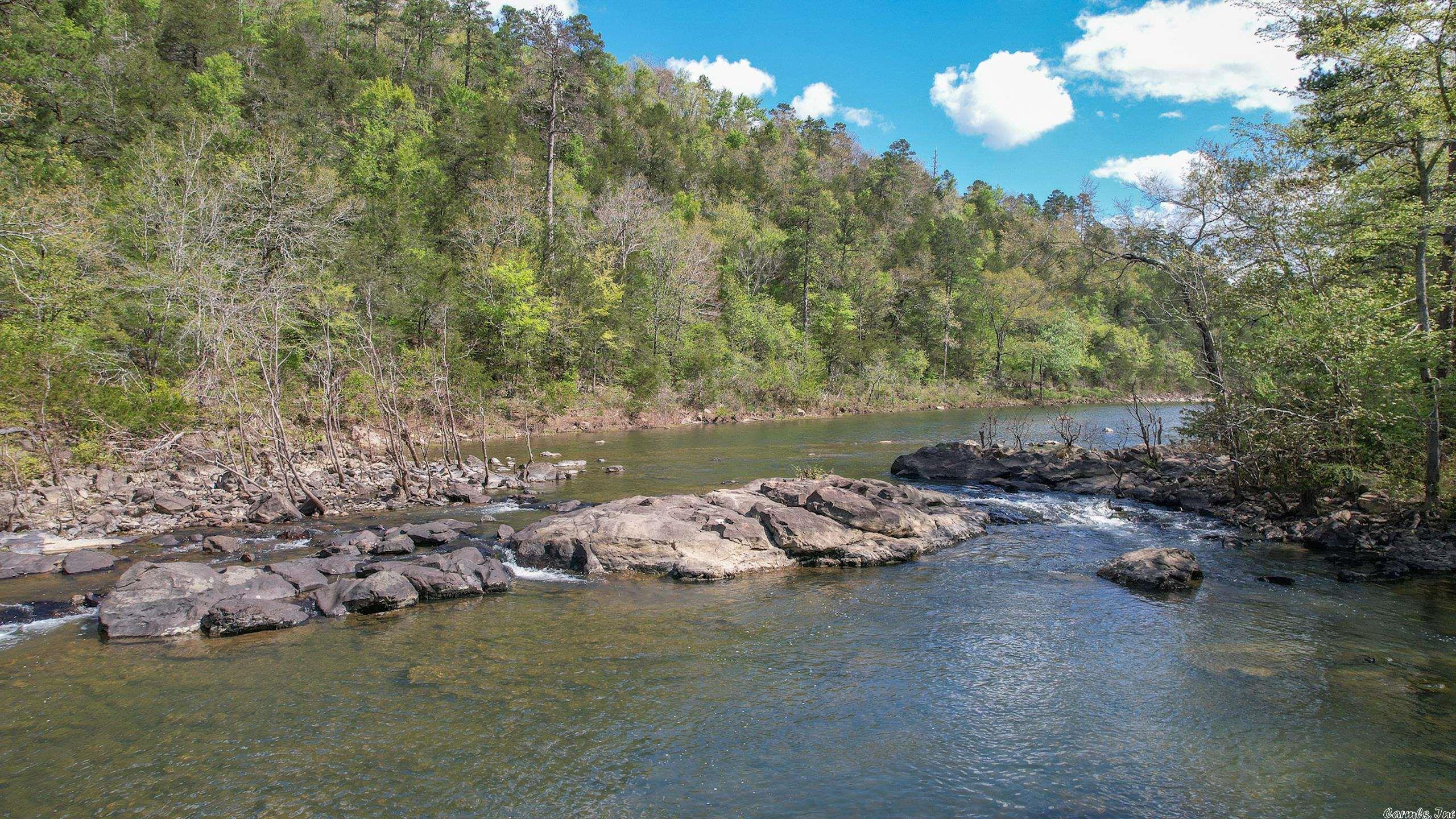 One of the most unique and most breathtaking properties that you will ever find. This beautiful tract of land is located on not just one but two waterways. Near the headwaters of DeQueen Lake, the property has miles of frontage on Rolling Fork River and Robinson Branch. Not accessible to the public, these crystal clear water ways are full of fish and provide you with your very own private swimming holes. With around 250 feet of elevation change, the property ranges from rolling hills to mountains with incredible view. The property is located at the end of a road providing the upmost in security and privacy. Miles and miles of gravel road will take you to the scenic areas, hunting locations and fishing holes. There are multiple stands and the owner has harvested some great whitetail deer, turkey and bear. To top it all off there is a Satterwhite log cabin located deep within the property, on the bluff of the river. With a wrap around porch, and bedroom, bathroom and a loft, there is room to experience the ultimate getaway. You simply canāt describe all this place has to offer, and do not want to pass up this once in a lifetime opportunity.