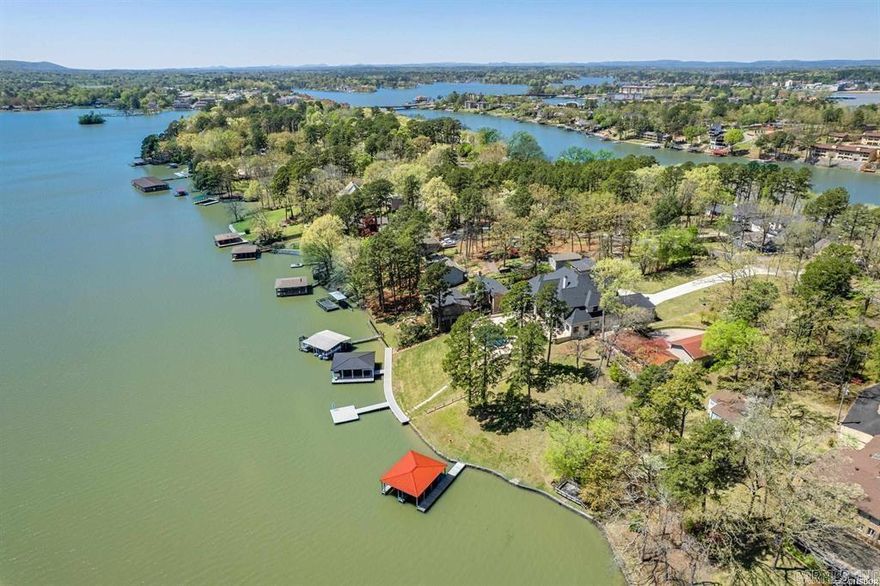 Discover this fantastic opportunity to own a well-maintained 3-bedroom, 2-bathroom home, PLUS a private 1 bedroom/1 bath garage apartment! Ideal for multi-generational living, guest accommodation, or a lucrative rental income stream. This property comes completely furnished and is move in ready. The 1,498 sq. ft. main home features a large family room and kitchen with open living layout and perfect for entertaining. The Master bedroom has an ensuite bathroom and private access to the deck. There are two guest bedrooms and a hall bathroom. Enjoy your evenings on the patio overlooking the large yard and beautiful views. The 550 sq. ft. garage apartment features a kitchenette, Open living and dining area with large windows and private entry. Bedroom and full bathroom. Double garage with two closets provide ample space for outdoor storage. Located directly on Lake Hamilton with gorgeous water and mountain views. Just steps away from the covered dock featuring two boat stalls each with a remote lift. This home is located on a large lake lot with approx. 125 feet of frontage as well as privacy, being one of last homes on the cul-de-sac. Call today to schedule your appointment.