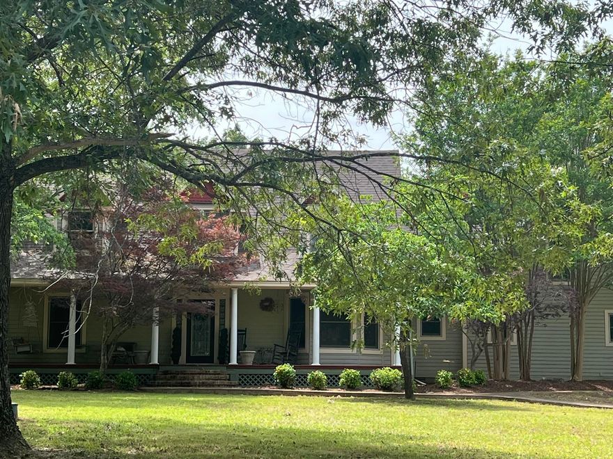 YOUR 'PLANTATION COUNTRY HOME' is 'move in ready' for a new owner!! Located on aprox.1.5 acres with large hardwood shade trees & beautiful landscaping. Quality built, home features: 4 bedrooms/ 2 1/2 baths, a gourmet eat in kitchen with 10 ft island, gas range, lots of cabinets with granite countertops. Other features: hardwood flooring, living room has an impressive vaulted ceiling, separate formal dining area, laundry room w/sink,1/2  hall guest bath & the generous  primary bedroom en-suite with walk in closet. The  primary bath has granite touches & a large tile shower. The other bedrooms are upstairs with another full bathroom & large living space or game room. Living room downstairs has French doors leading outside to the private veranda with flowering plants, ferns & canopying crepe myrtles trees. The level shaded estate offers a beautiful private shaded setting with a family firepit & a concrete pad for extra parking. There is a bonus room for additional space ready to complete for mother-in law suite if desired. It already has plumbing stubbed in for an additional full bath. Home is close to amenities, but in a private, quiet, up scale neighborhood.