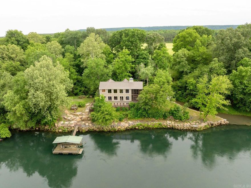 Riverfront Private Paradise!!!  This spectacular river home, designed by Rodney Parham, sits at the end of a gated subdivision with water on 3 sides!  The architect carefully planned this lovely home to take in the views of the Little Red River and the creek behind the house!  Built in 2009, 3 river lots including about 400 feet of river frontage, extensive and elaborate rock work permitted by the Corps of Engineers, 4-bedrooms, 3.5 baths, open kitchen/living/dining with 25 ft. tall fireplace and wall of glass overlooking the river!  Master suite on main level, 2-car garage, 2-screened porches with outdoor fireplace plus very large open deck, loft are overlooking living, metal roof, Andersen windows and doors, great boat-dock with covered boat slip and fishing platform, fly-tying and fishing gear room and much more.  The entire house, on all 3 levels, is stained wide-planked pine boards for the flooring, walls, ceilings and stairwells; the only sheetrock is in the gameroom.  This place is special...just wait until you see the privacy and quality!!!