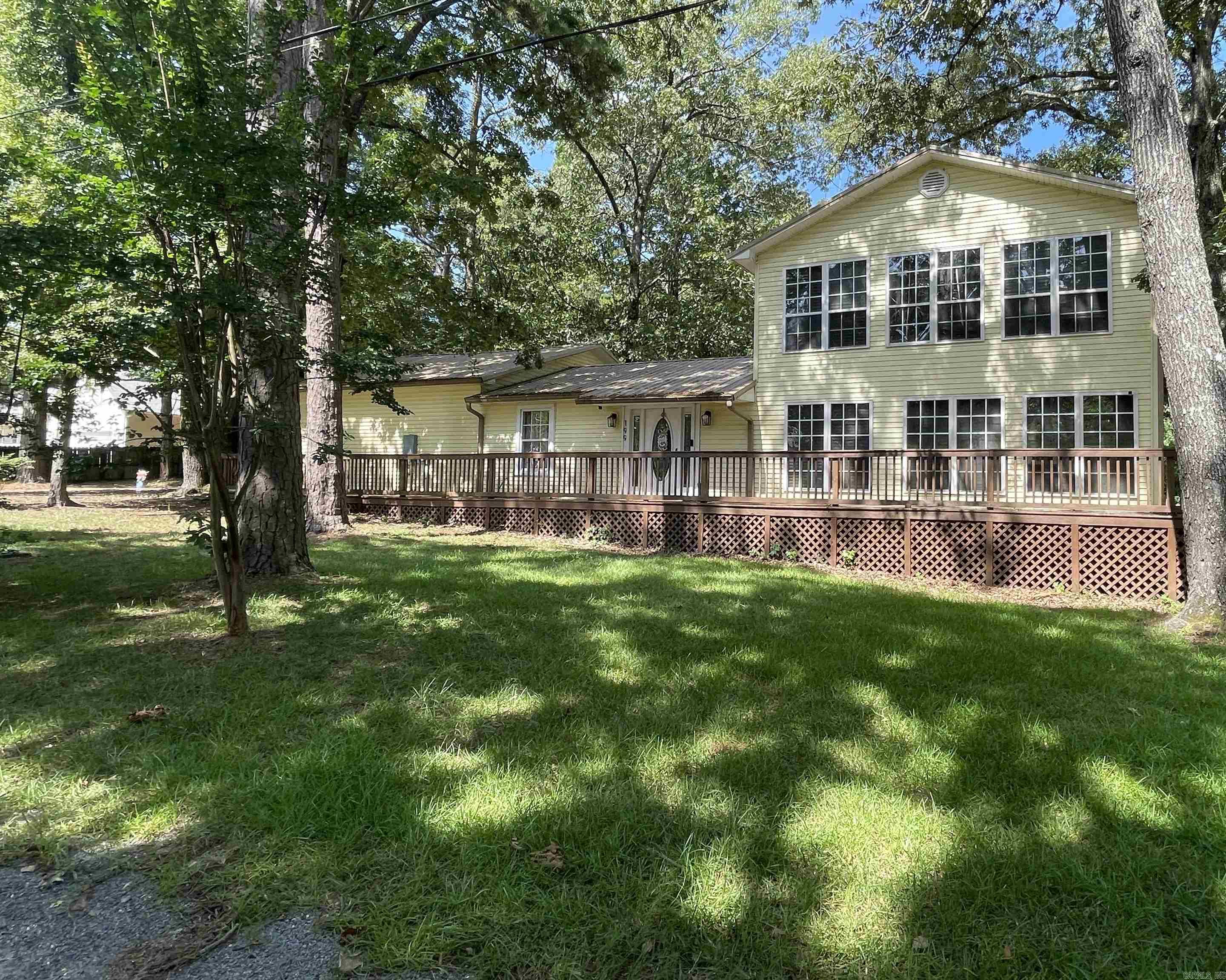 Need lots of square footage and storage everywhere? This home has it! 5 Bedrooms, 2 bathrooms, huge kitchen with butcherblock island, walk in pantry, separate laundry, Very large open living space. Free standing tub to soak in, walk in shower, and double vanities in large bath upstairs. This home was a total remodel down to the studs by previous owners in 2023. Luxury vinyl flooring, new sheetrock, paint, appliances, and gas surface range all new in 2022. Fenced back yard, huge back and front decks on a level lot that backs up to the woods. Metal roof, two car garage all under $90.00 per square foot. Home is being sold as is. Fridge, washer, and dryer all convey with accepted offer. Ring camera and alarm system stays with the home. Agents please see remarks.