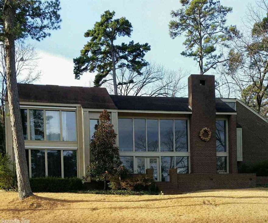 Contemporary style home with tall ceilings and open spaces.  Updated master suite with vaulted ceilings; outdoor entertaining area with flagstone patio and fireplace.  Walking distance to Raquet Club.