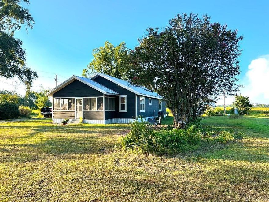This quaint farmhouse has been completely updated and is PRICED BELOW APPRAISED VALUE!!! This property sits in the most peaceful and serene location...farm fields for miles! It has a BRAND NEW HVAC, Roof, plumbing, updated electric, energy efficient windows, bathroom, exterior and interior paint, ceiling fans, lighting fixtures, tiled shower, carpet and refinished beautiful original hardwood floors. It also has all new custom blinds.  Sit in the evening on the screened front porch and watch the sunsets and enjoy a slower pace of life. All of this PLUS an acre of land, car shed and extra storage building!