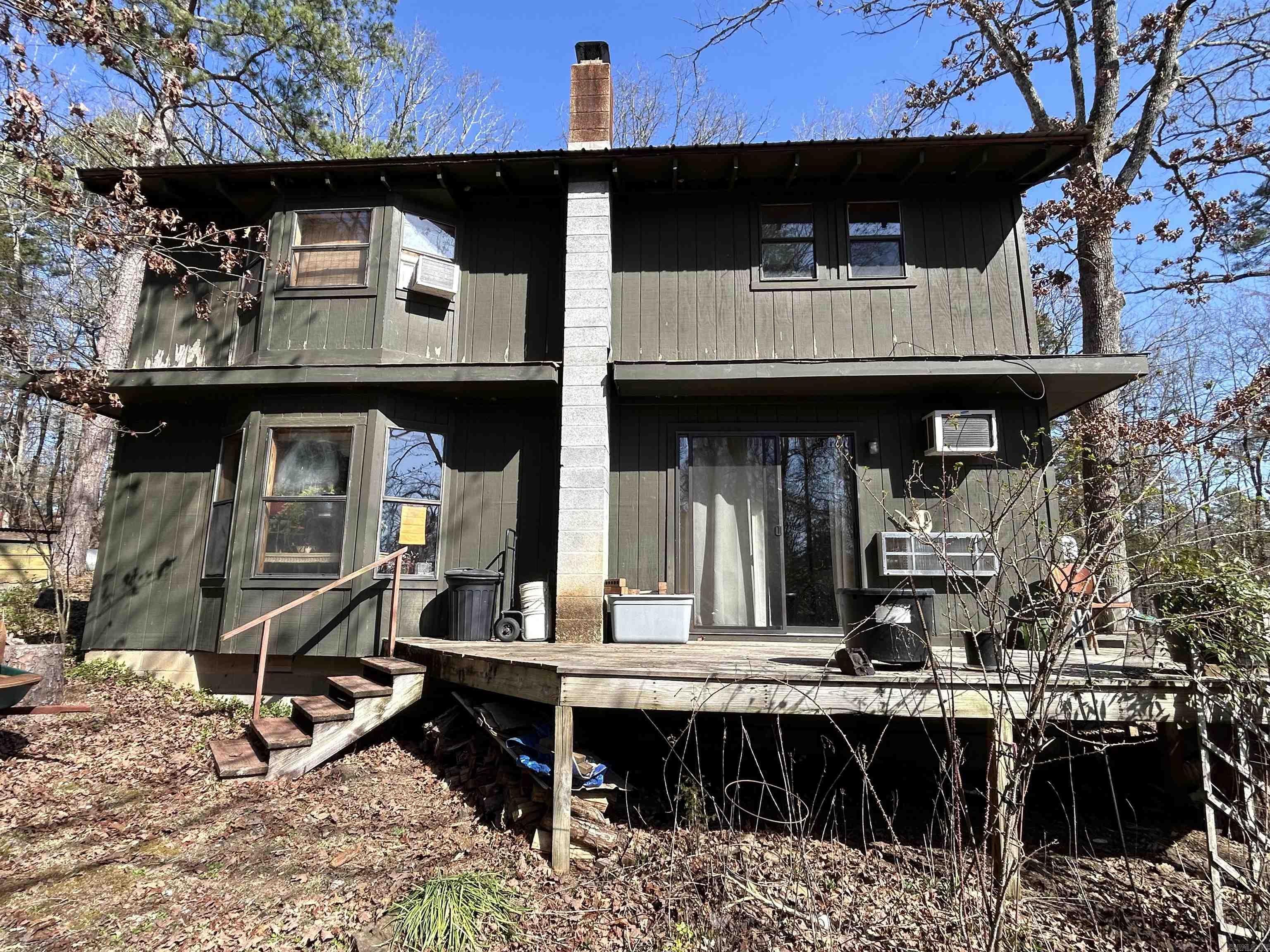 Have you ever wanted to own your own cabin in the woods? Here is your chance. This passive solar cabin sits on 3 acres in a very well spaced out neighborhood. This house was designed as a passive solar home. This means that during the winter the sun comes through the windows and provides extra warmth, while it is shaded by the trees and with the sun hitting the backside of the house it is kept cooler. There are a lot of places for you to sit and enjoy the solace that this home provides. Whether you choose to sit at your kitchen table next to three large windows looking out on your three acres and the variety of animals that come to visit, or to sit in front of a beautiful cast iron wood burning fireplace, or on the 3/4 wrap around porch, any of these would provide moments of peace and relaxation. There are 3 bedrooms here. One is downstairs while 2 are in the loft upstairs with a bathroom and a wonderful soaking tub and bathroom situated between the two rooms. Downstairs you find an open concept with the living room and kitchen. There is also a place for an office desk as you come through the main door. Close to Clinton, but it feels miles away from anything. Come see it today