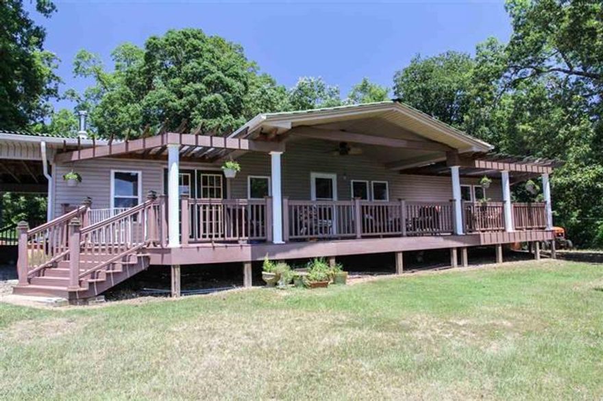 VERY UNIQUE PROPERTY. TWO DOUBLE WIDES SITTING ON APPROXIMATELY 15 ACRES. THESE PROPERTIES ARE SELLING MOSTLY FURNISHED AT NO VALUE PLACED ON THE PERSONAL PROPERTY.(SELLERS ARE MOVING OUT OF THE COUNTRY AND THE FURNISHINGS ARE TOO COSTLY TO SHIP).  MAIN HOUSE HAS GEO-THERMAL HVAC, PLUS VERMONT CASTINGS WOOD STOVE IN FIREPLACE AND STANLEY WATERFORD WOOD COOKSTOVE IN KITCHEN. THE KITCHEN SINK IS COPPER PLATED WITH FOOT CONTROLS. OUT BACK ON THE PATIO IS A MASONERY PIZZA OVEN THAT WILL AMAZE YOU,(SEE ADDENDUM)