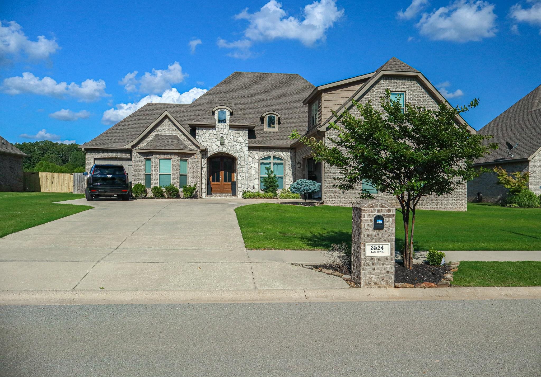 This thoughtfully designed home is ideal for a growing family, offering both functionality and comfort. Enter through the garage to find a mudroom/laundry area and a nearby half bath. The open-concept kitchen features ample cabinetry and flows seamlessly into a vaulted living room, highlighted by a beautiful stone fireplace with a cedar mantle. Step outside to enjoy a spacious covered back porch with an extended patio and a generously sized backyard, ideal for outdoor gatherings. The second and third bedrooms are well-proportioned and share a bathroom equipped with a dual-sink vanity. On the opposite side of the home, the private primary suite offers a peaceful retreat with a luxurious en-suite bathroom, complete with a soaking tub, separate tiled shower, and a walk-in closet. Upstairs, you'll find a versatile bonus space enhanced by a full bathroom and a walk-in closet perfect as a fourth bedroom, media room, or home office, with convenient access to the main level.
