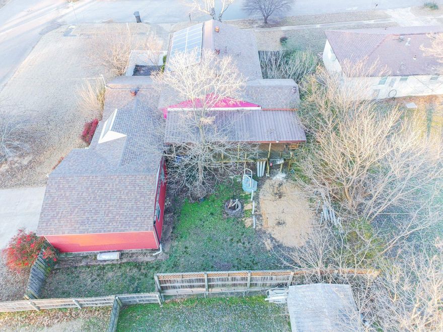 Welcome to 1214 Dana Street, a beautifully maintained home situated on a desirable corner lot featuring mature landscaping, including a weeping willow and a Japanese maple. The fully fenced property includes a gate across the front drive, creating a peaceful patio setting ideal for relaxing or entertaining.  The backyard offers a spacious covered porch, perfect for gatherings or enjoying the outdoors year-round. A two-car garage plus an additional third garage bay provides excellent storage for lawn equipment, tools, or recreational items. A covered walkway from the garage to the back entrance adds everyday convenience, making unloading groceries easy even during inclement weather.  Just inside the back entry, you’ll find a versatile room with cabinetry that works perfectly as an office, hobby room, or additional storage space. From here, enter the main living area where stairs lead down to a full basement offering abundant storage, a laundry room, two large rooms ideal for additional living space or a bedroom, and a full bathroom.  Upstairs features a beautiful living and dining area with French doors opening to a deck.  Make this home your's today! Call or text 870-253-2456.