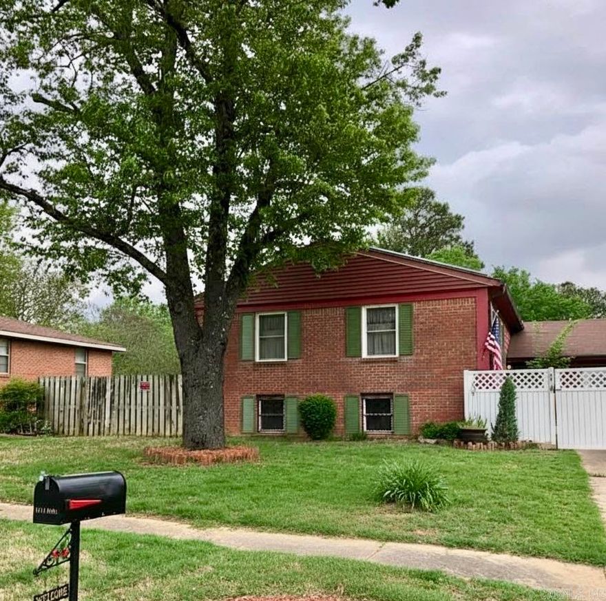 Welcome to 1214 Dana Street, a beautifully maintained home situated on a desirable corner lot featuring mature landscaping, including a weeping willow and a Japanese maple. The fully fenced property includes a gate across the front drive, creating a peaceful patio setting ideal for relaxing or entertaining.  The backyard offers a spacious covered porch, perfect for gatherings or enjoying the outdoors year-round. A two-car garage plus an additional third garage bay provides excellent storage for lawn equipment, tools, or recreational items. A covered walkway from the garage to the back entrance adds everyday convenience, making unloading groceries easy even during inclement weather.  Just inside the back entry, you’ll find a versatile room with cabinetry that works perfectly as an office, hobby room, or additional storage space. From here, enter the main living area where stairs lead down to a full basement offering abundant storage, a laundry room, two large rooms ideal for additional living space or a bedroom, and a full bathroom.  Upstairs features a beautiful living and dining area with French doors opening to a deck, as well as access to a sunroom with a wood stove.