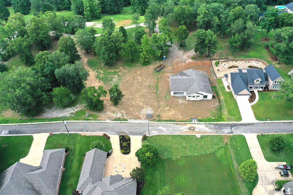 Discover a rare opportunity to own a prime building lot nestled in an exclusive gated subdivision just moments from the enchanting Garvan Woodland Gardens. This generously sized parcel offers the perfect blend of natural serenity and modern convenience. Lake Access Park: Enjoy private access to a well-maintained lakefront park on shimmering Lake Hamiltonāideal for picnics, kayaking, or sunset strolls. Modern Infrastructure: Equipped with all utilitiesāwater, sewer, electricity, and moreāready for your custom home to rise without delay. Pristine Roadways: Freshly paved blacktop streets with elegant curb and gutter design throughout the community. Stunning Vistas: Elevated views of Lake Hamilton offer a picturesque backdrop for daily living and entertaining. Whether you're looking to build a year-round residence or a weekend getaway, this tranquil lot provides a harmonious balance of privacy, nature, and accessibility.