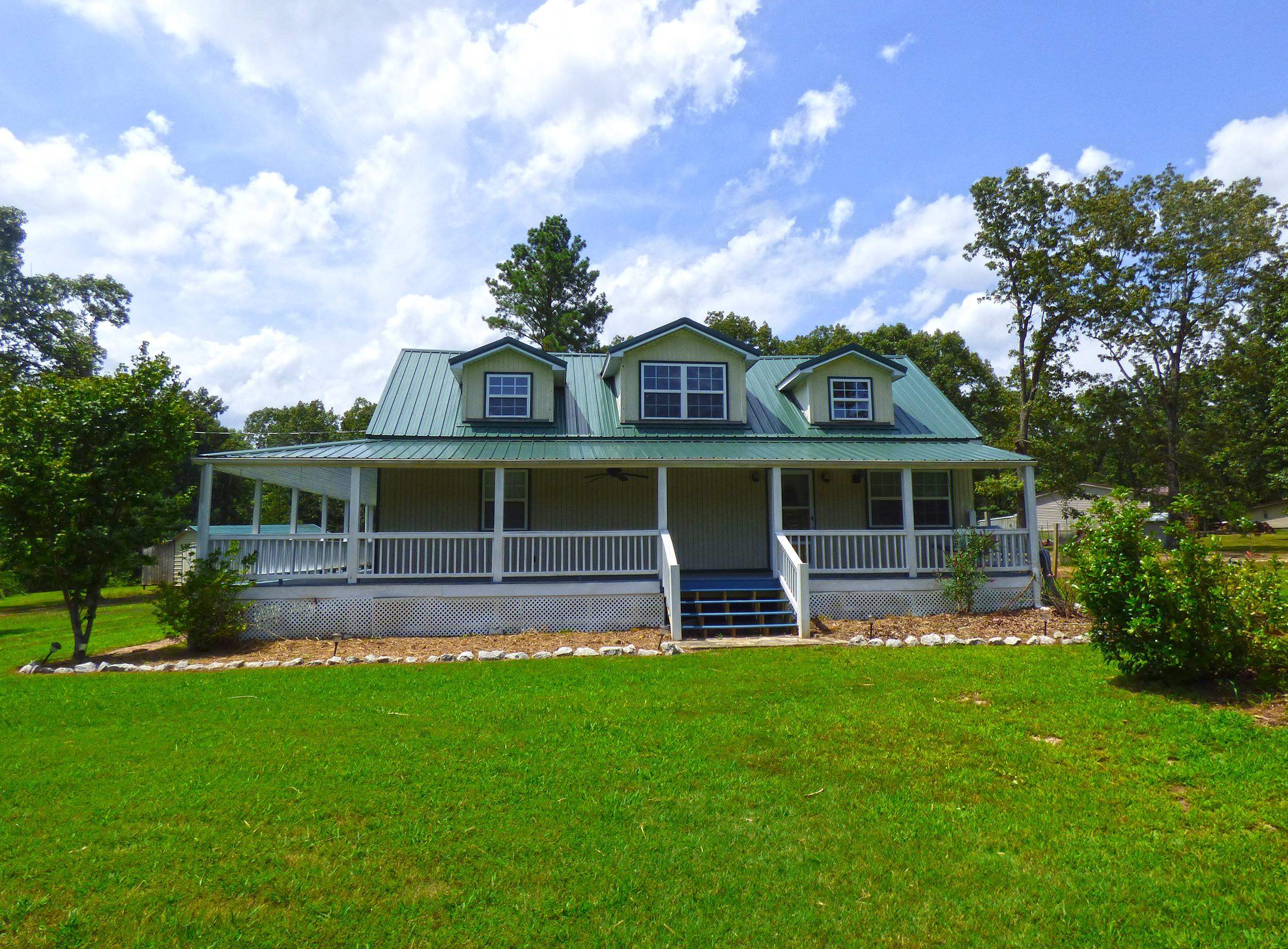 Three Bedroom House in 2+ Acres - This house offers open living-dining-kitchen room, 3 bedrooms, 2 baths, laundry/utility room. Plus an upstairs bonus area. Nice covered front porch and covered back deck, lots of backyard space for gilling, having a firepit, garden, & entertaining. House has a metal roof, detached carport, and storage building. This is all on 2.3 acres of land. Country Living that's not far from town.