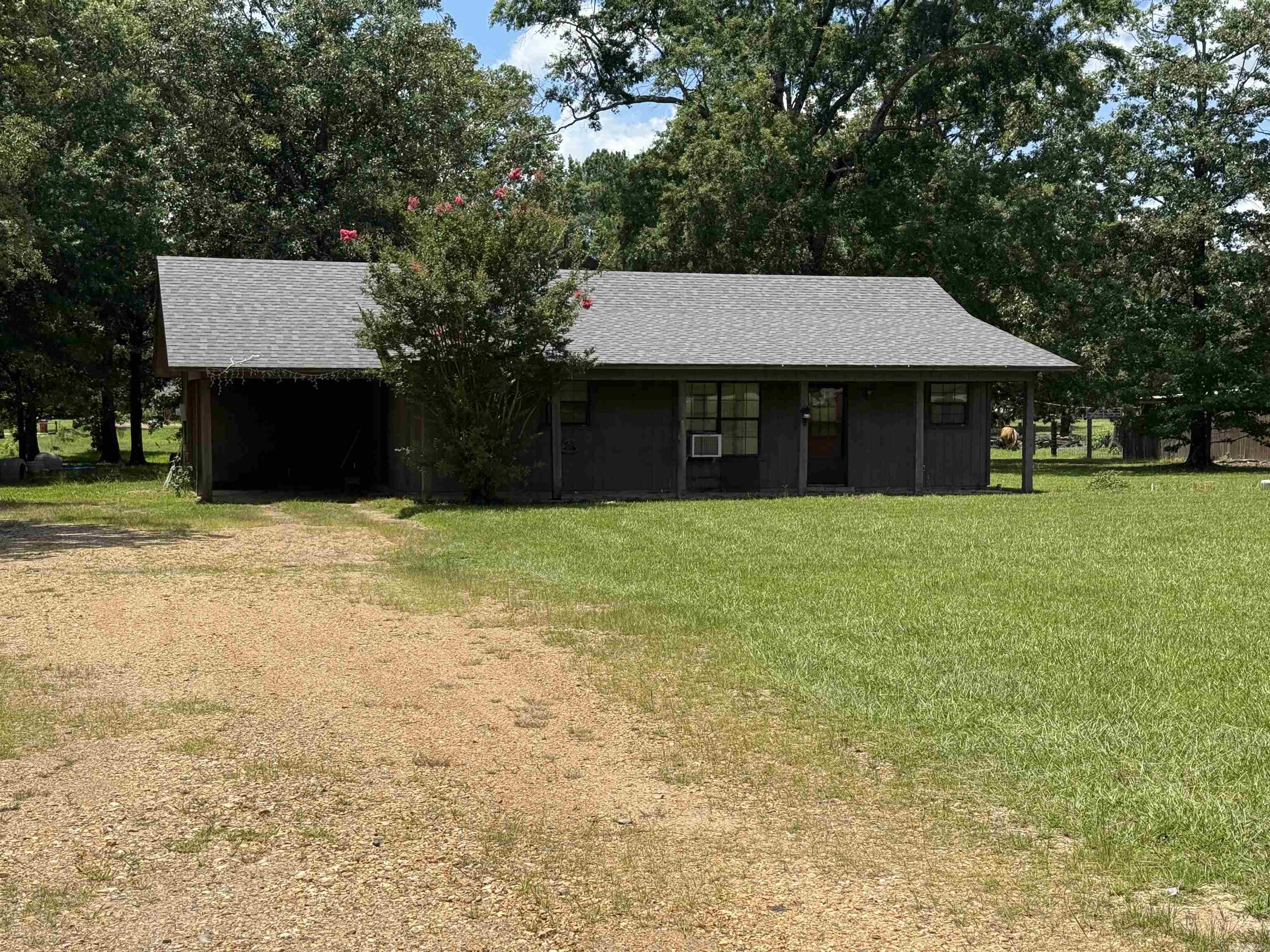 This home is the perfect space to downsize or a starter. With enough room to spread out on over 2 acres and close to town it's a great location. 2 bed 2 bath interior are great for privacy. While the vaulted ceiling and open living/dining make it feel open. Lots of space in the kitchen for great family meals. Make some minor updates and feel right at home.