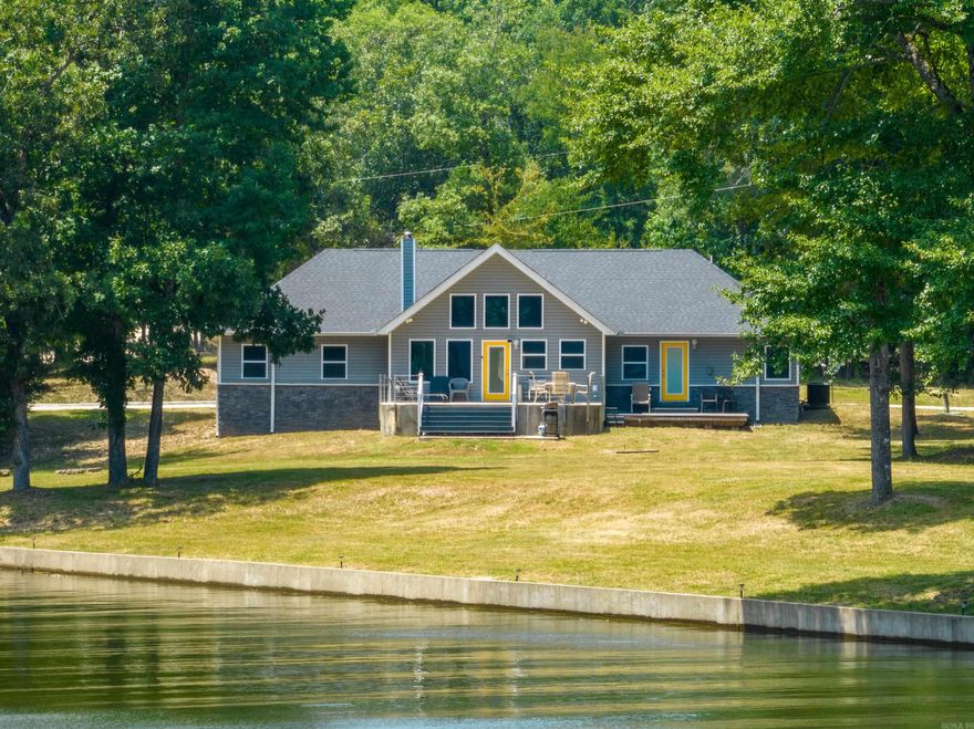 Lake living at its finest! This stunning 2218 sq ft residence built in 2020 sits directly on the picturesque shores of Lake Hamilton, boasting an impressive 145' of prime lake frontage. With a meticulously crafted seawall and a private covered boat dock, water activities can be enjoyed right from your doorstep. Unrivaled panoramic views of the main channel greet you through the expansive wall of windows in the living room, offering a seamless connection to the natural beauty surrounding you. Entertain with ease in the chef's kitchen, seamlessly integrated into the living space and adorned with soaring 12' vaulted ceilings. Retreat to the tranquil master bedroom, complete with access to a private patio overlooking the serene lake vistas. Pamper yourself in the luxurious master bath ensuite, featuring a rejuvenating whirlpool bathtub and a separate shower. Perfect for savvy investors, this property holds immense potential as a lucrative short-term rental. Furnishings negotiable with acceptable offer. Don't miss this rare opportunity to own a slice of lakefront paradise!