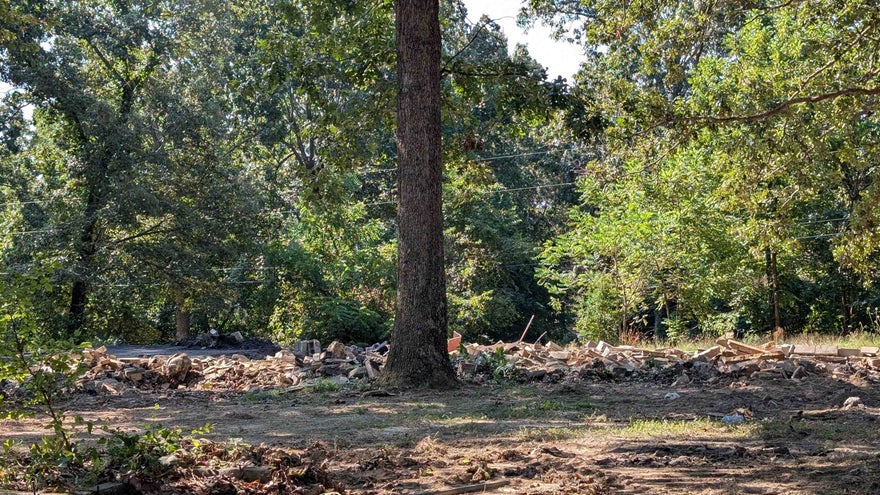 Level, Buildable lot only a few blocks from Crown Lake pier. Driveway and septic on site from previous fire. Water and electric hookups from previous home. NAEC fiber optic internet available. Per bill of assurance, home to be min 850 sq ft plus carport. Broker owned.