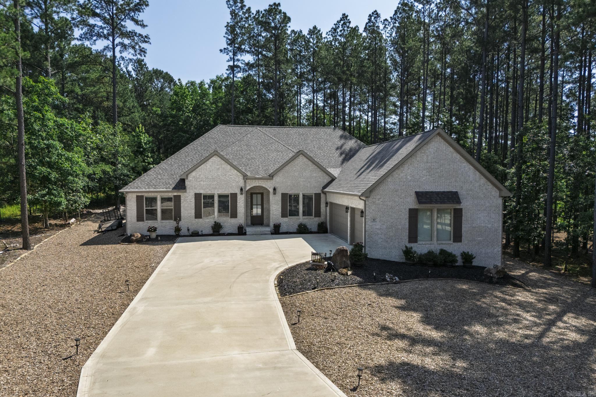 This stunning 3 year old brick home located on the #16 tee of Granada Golf course, offers a perfect blend of modern luxury and comfort. With 3BR/2.5B and a private office, it's ideal for both relaxation and productivity. The open kitchen boasts beautiful cabinetry, a gas range, built-ins, and separate pantry for ample storage. The open floor plan features a vaulted wood beam ceiling, a cozy gas fireplace with built-ins on each side. Upgrades include energy efficient automated Hunter Douglas Silhouette Power view shades with Wi-Fi smart home integration, professionally installed gutters and leaf guards along the entire perimeter of home, Reme Halo LED whole house air purifier, drip irrigation system, and solar lights on driveway and patio. Upgraded carpet pad feels like walking on air! Professionally installed stone border around landscape beds which finish off the yard for a beautiful touch. Step outside to a covered patio overlooking the backyard and golf course. The 3 car garage boasts a stairway to storage area above, and with over 1/2 acre lot you get loads of privacy like country living! Truly a MUST see home!