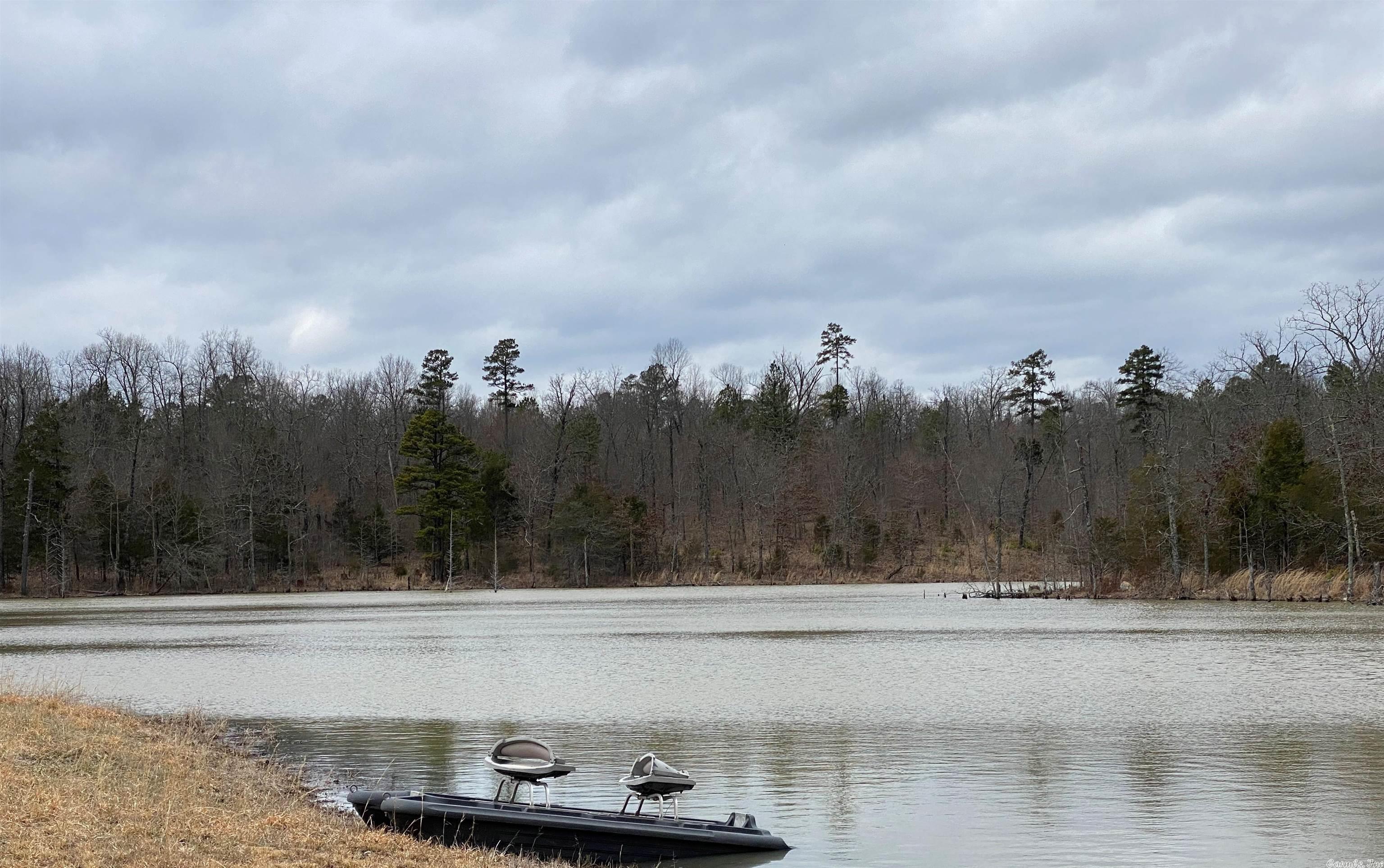 This large tract has a private lake, stocked with fish, that is 4.5 acres of water. It is an excellent hunting & recreational property. Has a close proximity to a good restaurant & the large Federal Lake Norfork. Also comes with 2 older fixer-upper double wide trailers; both have drilled water wells. There is a 3 bay garage & 2 metal buildings. Only 10-15 min to the Lake Norfork Dam, the large Quarry marina, & the Jordan Landing on the Lake. Will sell in smaller tracts of acreage.