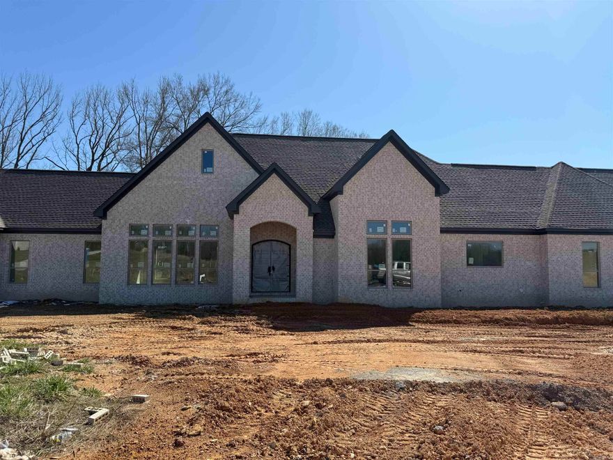 This stunning all brick house has 4 bedrooms, 2.5 bathrooms, and a porte cochere leading to a three car garage. This home sits on 1.86 acres, and features an iron front door, double islands in the kitchen, an island in the primary closet, two electric fireplaces inside, and a wood burning fireplace on the covered back porch. It has 12 ft ceilings in the main areas, and 10 ft ceilings through out the rest of the home, featuring 8ft interior doors through out. Call today to schedule your own private showing.