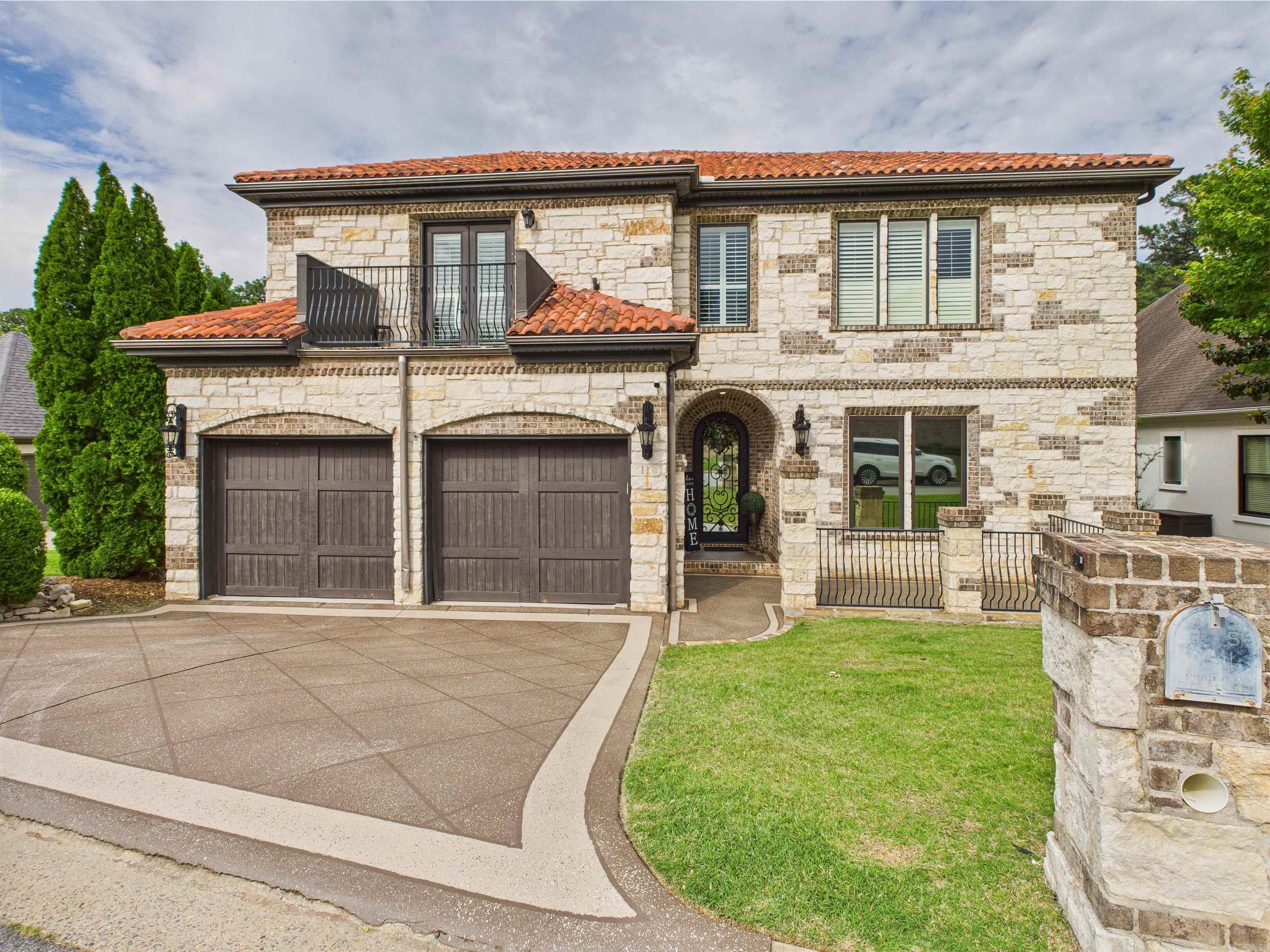 24hr notice to show: This beautiful home has custom architectural detail that will amaze you! Two story great room with arched detail, dining with full-service bar, gourmet kitchen- heavy granite counter tops, double oven, and your very own wine cellar! An awesome custom movie theatre with remote controlled window covers 2-bedroom suites & open loft upstairs. Guest suite and Primary suite located downstairs! The Primary bedroom boasts cherry wood floors, sitting area, private patio access, 2 showers (1 steam) & jacuzzi tub with attached walk-through laundry. Large walk - in closets! Enjoy outdoor entertaining on stone patio/courtyard that overlooks fenced yard with a creek and permanent green space for privacy, Custom Real Wood window blinds, remote controlled window coverings! Automatic blinds in theatre room. **HOME WARRANTY**