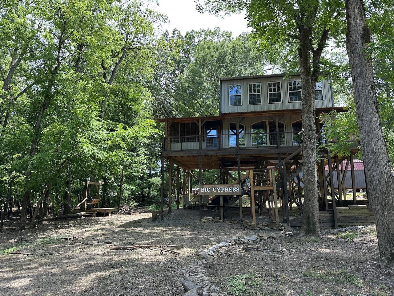 Experience riverside living in this awesome retreat with 1 BR/1BA on the main floor and a bunk area and second living space upstairs. This cabin offers a wonderful landscape with abundant natural lighting and rustic interior. A wrap around balcony is the perfect place to unwind and enjoy the views of the Little Red River. The cabin also has a dumb waiter/pulley system for bringing a big load upstairs all at once. Listing includes vacant lot to the east. Across the Little Red River is Hurricane Lake WMA with 16k acres of public duck, deer and small game hunting. The Nimmo boat ramp is just 1/2 a mile from the cabin and its a very short drive to Raft Creek WMA and a very short boat ride down river to the confluence of the White River for fishing and the sandbars! Barnwood used inside the cabin is from a barn in Star City that was built in 1910. The cabin has city water, septic system, and Entergy for electric service. Window units keep it cool in the warmer months and wood burning stove provides heat in the winter. Cabin is being sold fully furnished as seen in the photos. Make this cabin your hunting/fishing headquarters!