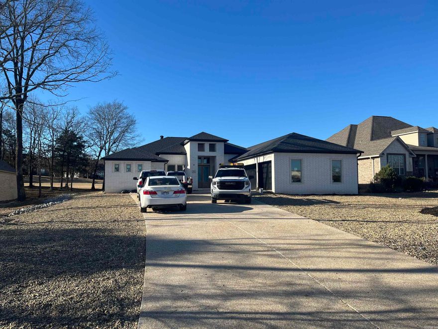 New Construction Isabella Golf Course Contemporary Luxury Experience refined golf-course living in this new construction contemporary home ideally positioned on a level lot along the Isabella Golf Course in Hot Springs Village. Designed with both style and function in mind, this residence offers sweeping golf course views and a seamless indoor–outdoor connection. High-end finishes and attention to details define the upscale aesthetic, while thoughtfully designed living spaces provide comfort and flexibility for everyday living or entertaining. Expansive windows frame fairway views and flood the home with natural light, enhancing the open-concept layout. The kitchen features premium materials, custom cabinetry, and upscale fixtures, complementing the home’s contemporary design. Quality craftsmanship is evident throughout, from the curated finishes to the efficient floor plan that maximizes the level setting and golf-front location. Enjoy the tranquility of golf-course living with the convenience and amenities of Hot Springs Village, including multiple golf courses, lakes, trails.  Taxes are based on unimproved lot, consult the county assessor for taxes with home constructed.