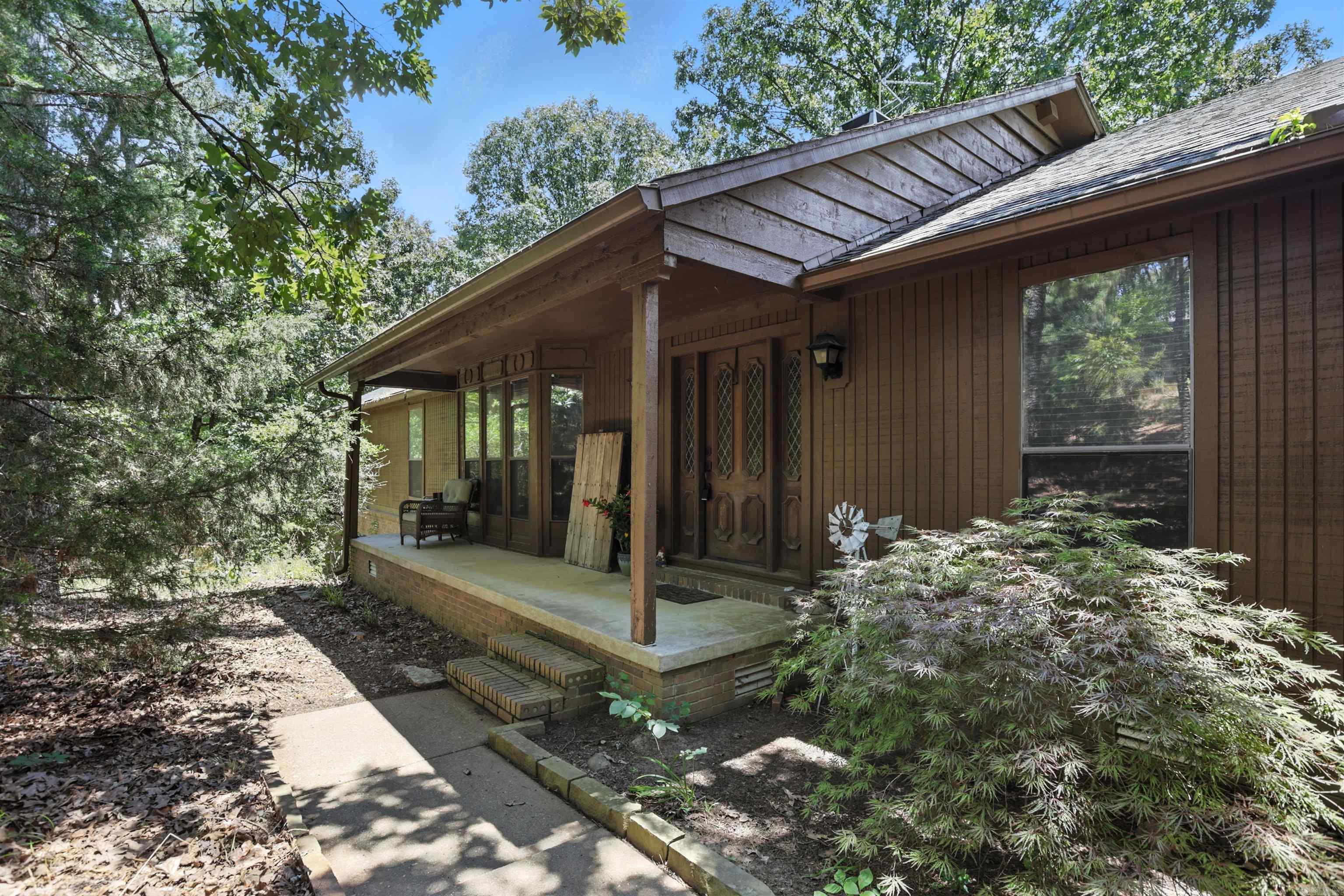 Tucked just off the Morgan/Maumelle exit, 6307 Sunset Trail gives you quick interstate access without giving up that peaceful, out-of-town vibe. Youāll love the open layout and the walls of windows - the natural light is next level. The oversized kitchen is perfect for hosting and flows into a cozy living area with a pass-through fireplace. Outside, enjoy a dreamy screened-in porch, traditional deck, fenced yard, and even a greenhouse. Major updates include a newer roof, HVAC, tankless water heater, and marble kitchen counters. Thereās also a hot tub, workshop space, and a partially finished basement (not included in sq ft) that makes a great hangout or storm-safe spot. Quiet, spacious, and full of charm; schedule your showing now!