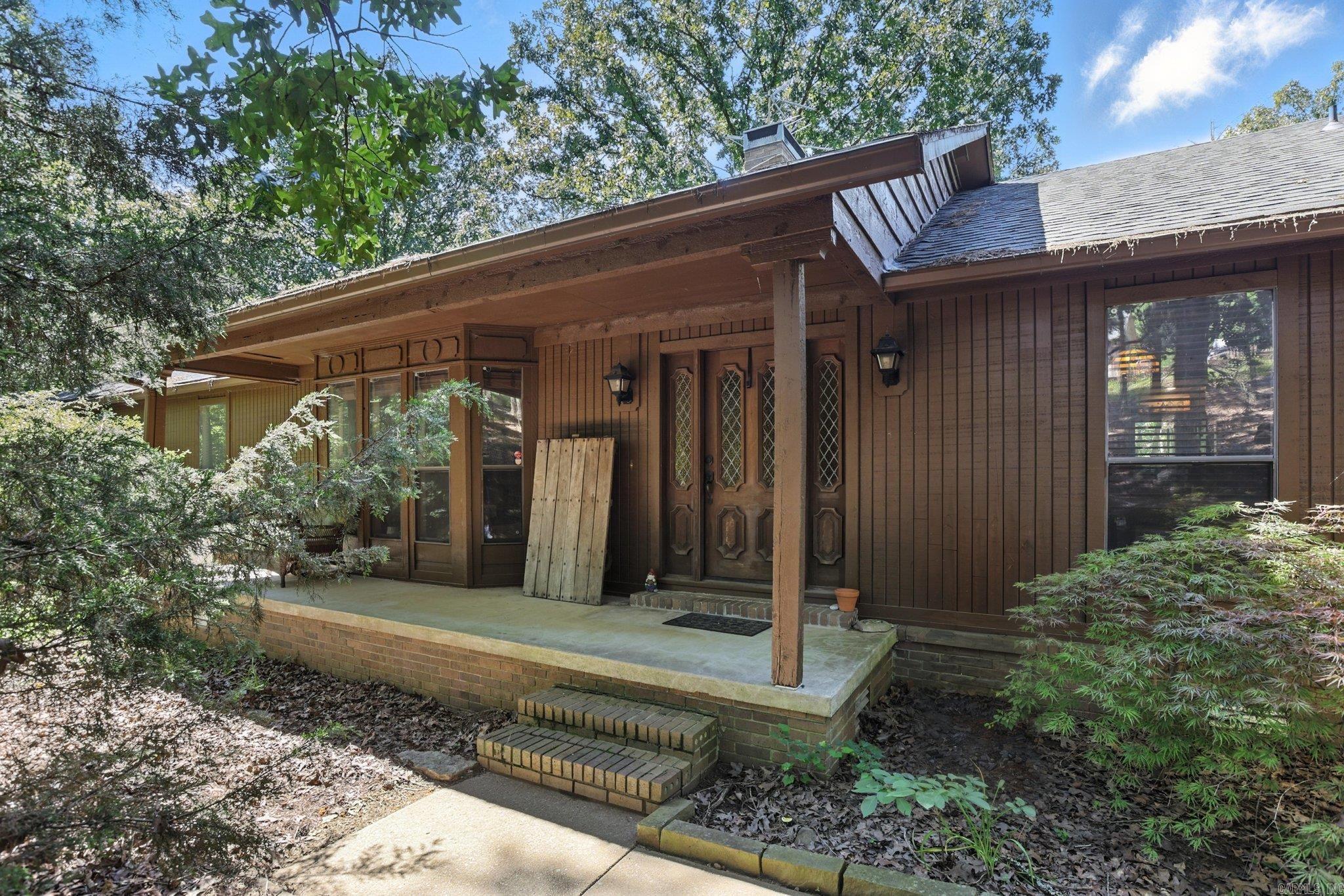 Tucked just off the Morgan/Maumelle exit, 6307 Sunset Trail gives you quick interstate access without giving up that peaceful, out-of-town vibe. You’ll love the open layout and the walls of windows - the natural light is next level. The oversized kitchen is perfect for hosting and flows into a cozy living area with a pass-through fireplace. Outside, enjoy a dreamy screened-in porch, traditional deck, fenced yard, and even a greenhouse. Major updates include a newer roof, HVAC, tankless water heater, and marble kitchen counters. There’s also a hot tub, workshop space, and a partially finished basement (not included in sq ft) that makes a great hangout or storm-safe spot. Quiet, spacious, and full of charm; schedule your showing now!