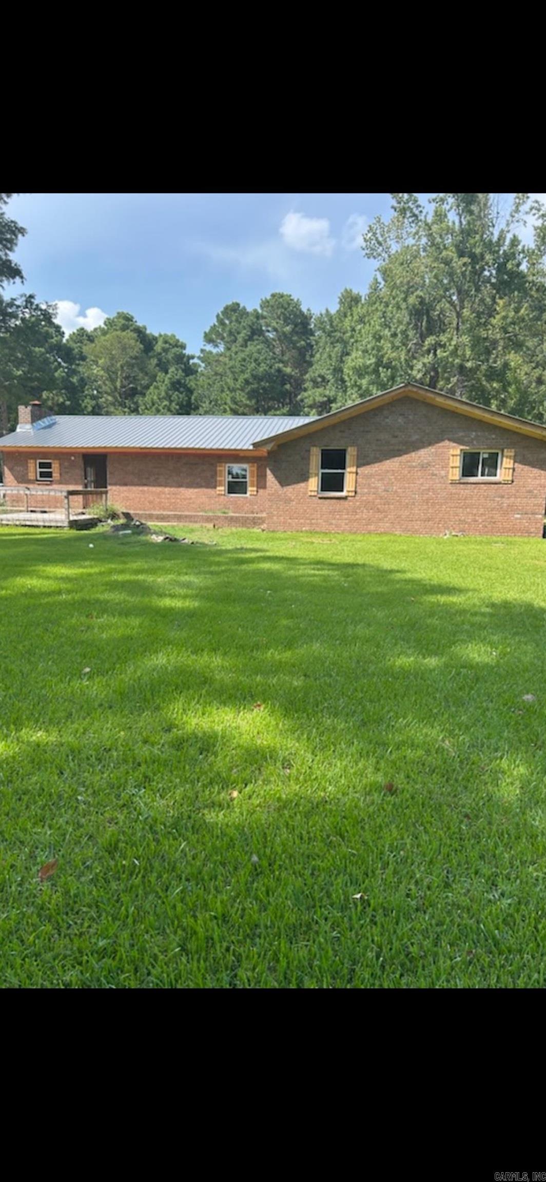 All brick *** Brand new windows and metal roof *** Needs to be completely refinished on the inside *** Here's the deal *** on one level acre with pretty trees *** See agent remarks for showing instructions ***