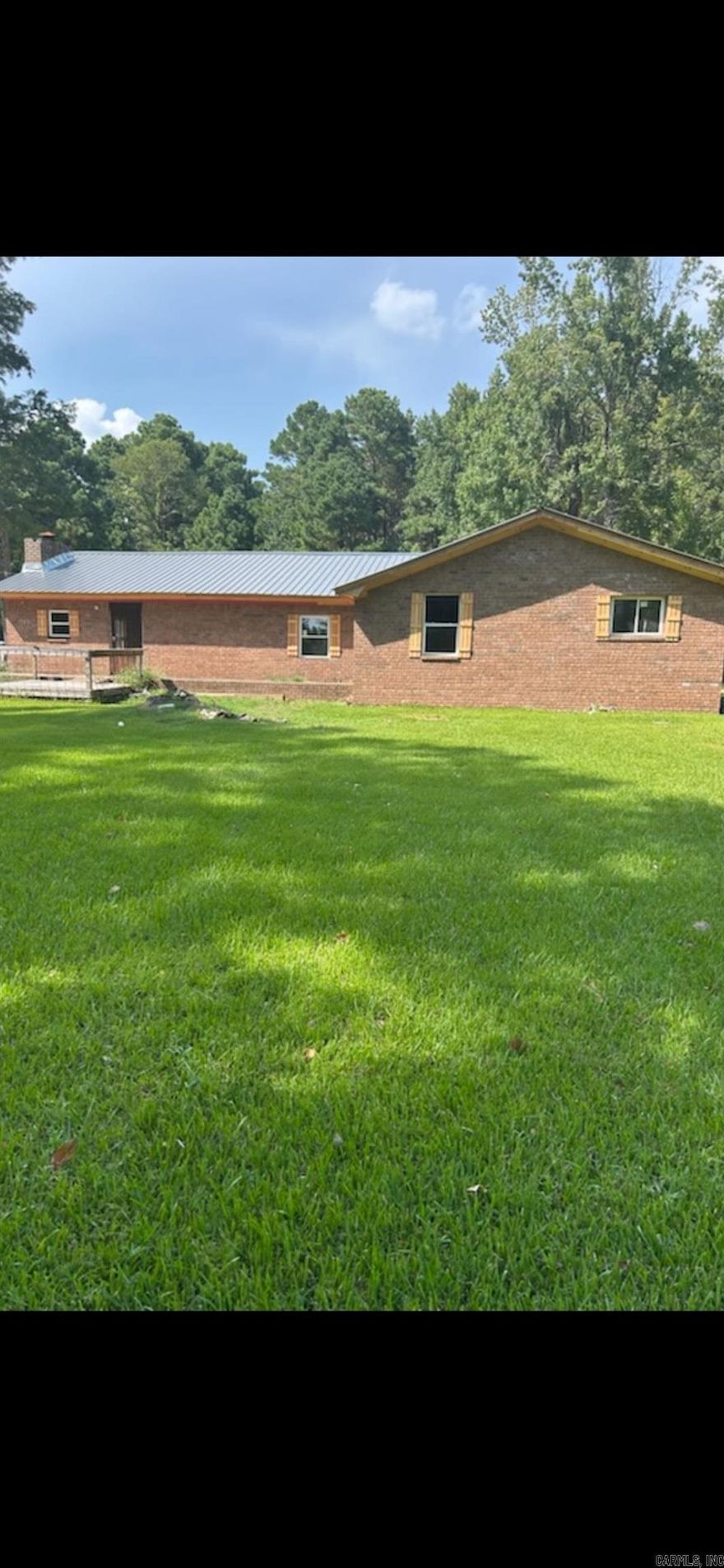 All brick *** Brand new windows and metal roof *** Needs to be completely refinished on the inside has been completely gutted *** Here's the deal *** on one level acre with pretty trees  *** See agent remarks for showing instructions ***