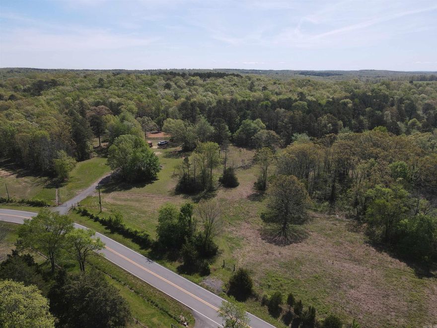 This 4.84-acre surveyed tract in Van Buren County, Arkansas, offers a beautiful mix of open fields and mature trees, making it an ideal setting for your future home. Located on paved Holly Mountain Road with county road frontage, the property features a gated entrance, a gravel driveway, and an existing building pad ready for development. Utilities are on the property, including city water, electric, and high-speed fiber internet. With both privacy and convenience, this property offers a perfect balance of natural beauty and modern amenities.