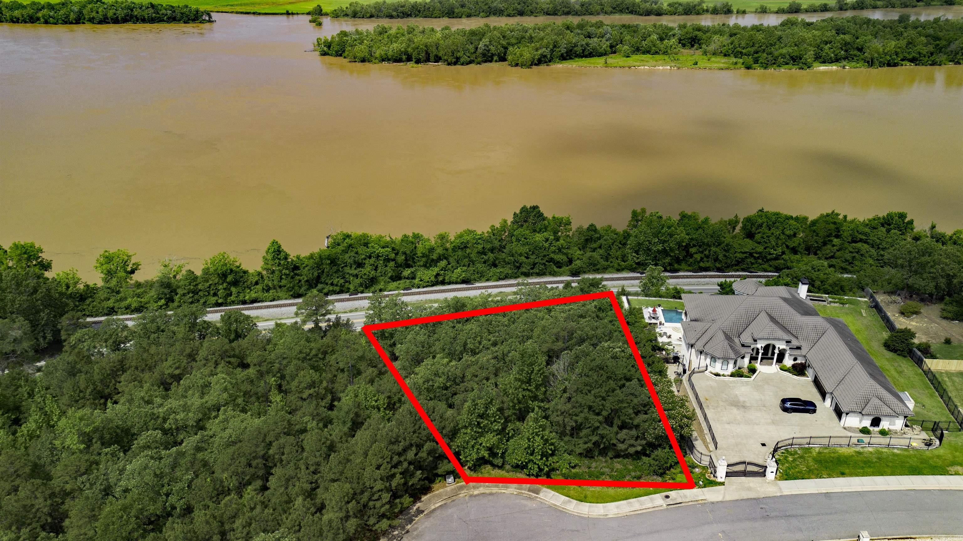 Perched atop a scenic peak, this beautiful 0.89-acre lot offers sweeping views of the Arkansas River—an ideal setting for your dream home. Located behind a gated entrance, the property offers added privacy and security. With utilities already at the road and mature trees throughout, the land is ready for you to shape to your vision. Its elevated position provides not only breathtaking views but also a peaceful, tucked-away feel—while still keeping you close to all the essentials. This is an opportunity to build something truly custom in a location that feels like a retreat. Utilities are at the road.