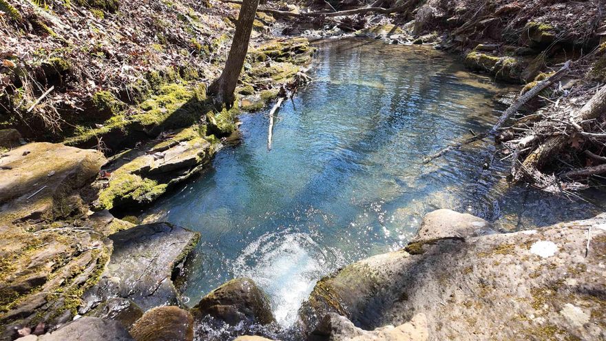 Wooded land with a view.  Just 15 minutes outside the town Clinton, Arkansas, this land is a fresh canvas for you to set your home exactly where you want it, either close to the road or down the hill just a bit for the best views possible. Build your new home with a large porch to enjoy the valley below.  With large boulders, mature timber and a wet weather creek at the bottom.  For hunters, plan to build targets across the valley and gear up for hunting season where you can find deer, turkey, bear and more through the area.