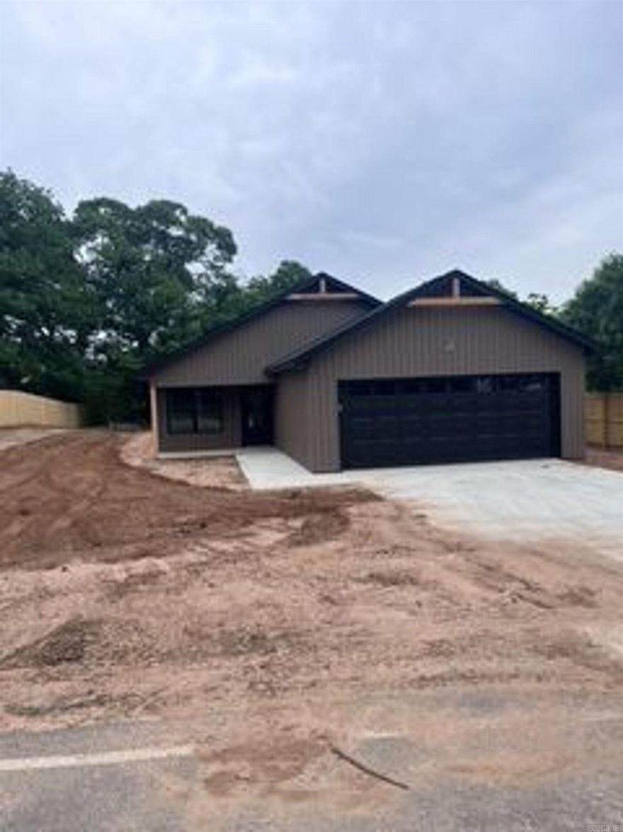 Beautiful New Construction in Bauxite.  Welcome home to this stunning 3-bedroom, 2-bath new construction in Bauxite, offering the perfect blend of modern style and everyday functionality. This thoughtfully designed home features an open-concept layout with vaulted ceilings, creating a bright and spacious living area ideal for both relaxing and entertaining.  The kitchen is a true highlight, complete with elegant quartz countertops, a pantry for added storage, and all-electric appliances including a freestanding range and dishwasher—making it as practical as it is beautiful.  Enjoy durable luxury vinyl flooring throughout and cozy evenings by the electric log fireplace. The home offers approximately 1,540 square feet and is built on a slab foundation with energy-efficient all-electric systems, including central heat and air, water heater, and laundry hookups.  Step outside to a covered back porch overlooking a generous 0.3-acre lot—perfect for outdoor gatherings or quiet mornings.  Additional features include a floored attic for extra storage. Located in the  Hillcrest subdivision, this home checks all the boxes for comfort, style and convenience.