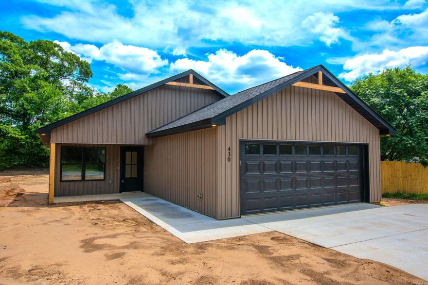 Beautiful New Construction in Bauxite.  Welcome home to this stunning 3-bedroom, 2-bath new construction in Bauxite, offering the perfect blend of modern style and everyday functionality. This thoughtfully designed home features an open-concept layout with vaulted ceilings, creating a bright and spacious living area ideal for both relaxing and entertaining. Kitchen is a true highlight, complete with elegant quartz countertops, pantry for added storage, all-electric appliances including freestanding range and dishwasher making it as practical as it is beautiful. Oversized garage with 18' door. Fenced bk yard.   Enjoy durable luxury vinyl flooring throughout and cozy evenings by the electric log fireplace. The home offers approximately 1,540 square feet and is built on a slab foundation with energy-efficient all-electric systems, including central heat and air, water heater, and laundry hookups.  Step outside to a covered back porch overlooking a generous 0.3-acre lot—perfect for outdoor gatherings or quiet mornings.  Additional features include a floored attic for extra storage. Located in the  Hillcrest subdivision, this home checks all the boxes for comfort, style and convenience.
