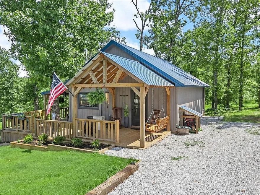 A true gem in the Ozarks!   6.15± acres w/breathtaking sunrise views, this charming 840 sq ft cabin, built in 2022, is ideally located just 3.5 miles down easy back roads from the Buffalo River & the historic town of Gilbert, AR.  The cabin features vaulted ceilings, spacious primary bedroom, cozy bunk room & a loft-style bedroom—comfortably sleeping up to 6 guests. The full bath includes a large jetted soaking tub w/a shower combo for spa-like relaxation.  Enjoy outdoor living on the expansive wraparound deck, perfect for entertaining or soaking in the peaceful surroundings.  In addition, the property includes a two-car covered parking area attached to what could easily be finished into a studio apartment. It’s already prepped for a kitchenette and bathroom—just waiting for your finishing touches. Whether you're looking for a private retreat or an investment opportunity, this property offers incredible potential. With room to add additional cabins, stunning views, & undeniable charm, this is a five-star opportunity
