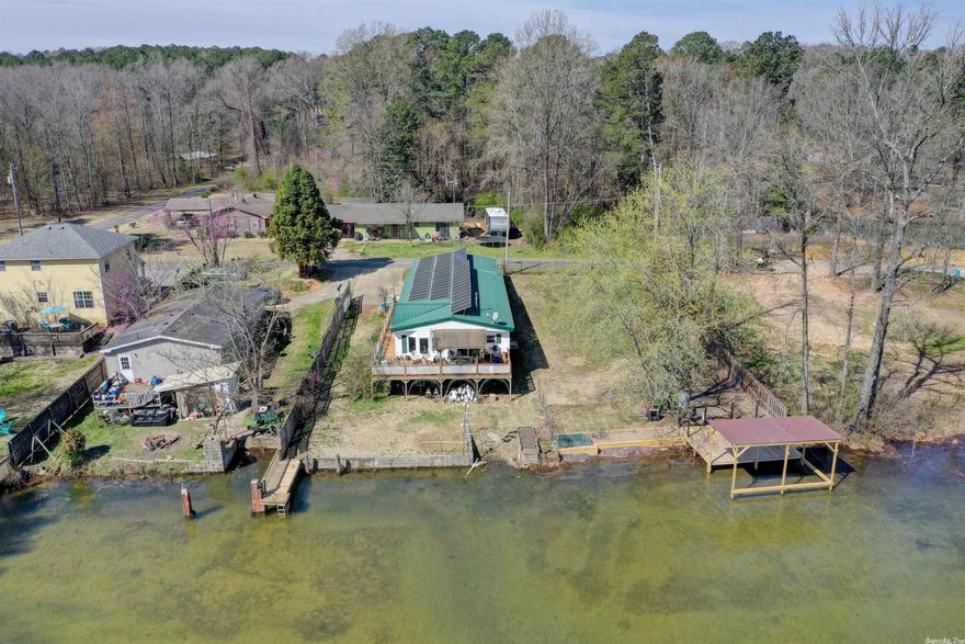 Looking for a lake-front home with a boat dock and solar located in the Lake Hamilton School District? Look no further! This 3 bedroom, 2 bath manufactured home is perfect for summer fun and relaxation. The quiet neighborhood provides a peaceful retreat, while the lake access and boat dock offer endless opportunities for water activities. Don't miss out on this amazing opportunity to own your own slice of lake-front paradise! Looking for a home that when you aren't relaxing and making memories here, you can rent it out so others can enjoy all the beauty your home has to offer! Do not miss this opportunity!