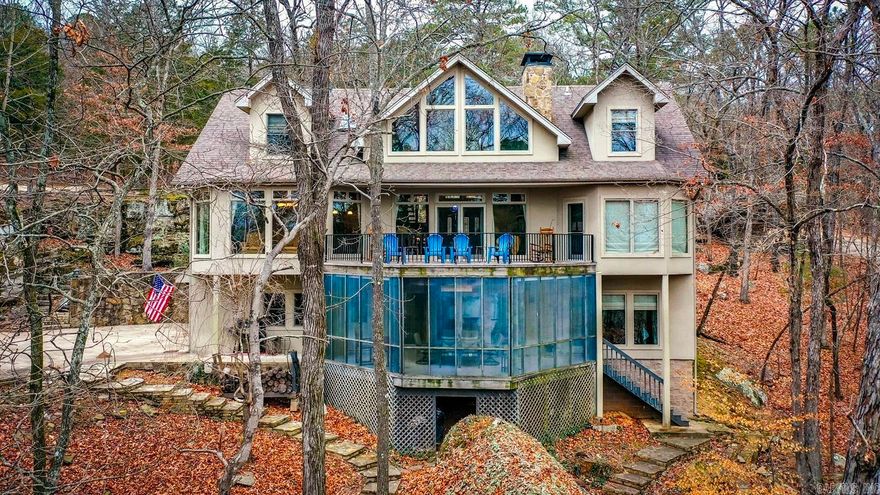 LAKEFRONT!!! LAKEVIEW!!! EASY WALK TO THE WATER!!!...Nestled in Snake Head Cove on Greers Ferry Lake, this exceptional 5-bedroom, 3.5-bathroom lakefront property offers a luxurious retreat. Boasting two spacious living areas, a beautifully updated kitchen, and large windows that frame breathtaking views, this home invites you to experience lakeside living at its finest. A walk-out basement, three-car garage, and a screened back porch enhance the allure of this residence, providing convenience and opportunities for relaxation. Imagine entertaining on the large back deck, taking in the panoramic view of Sugarloaf Mountain and Snake Head Cove. With this property, your backyard isn't just any backyard – it's graced by the presence of the renowned Snake Head Rock, a natural masterpiece that becomes a part of your daily landscape.